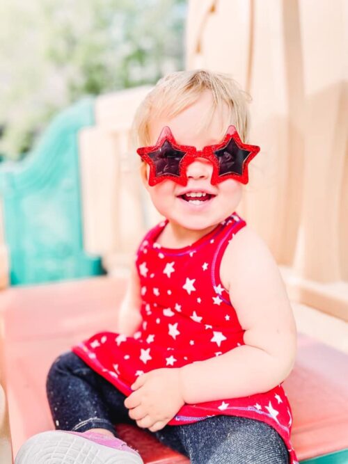 toddler wearing red star sunglasses
