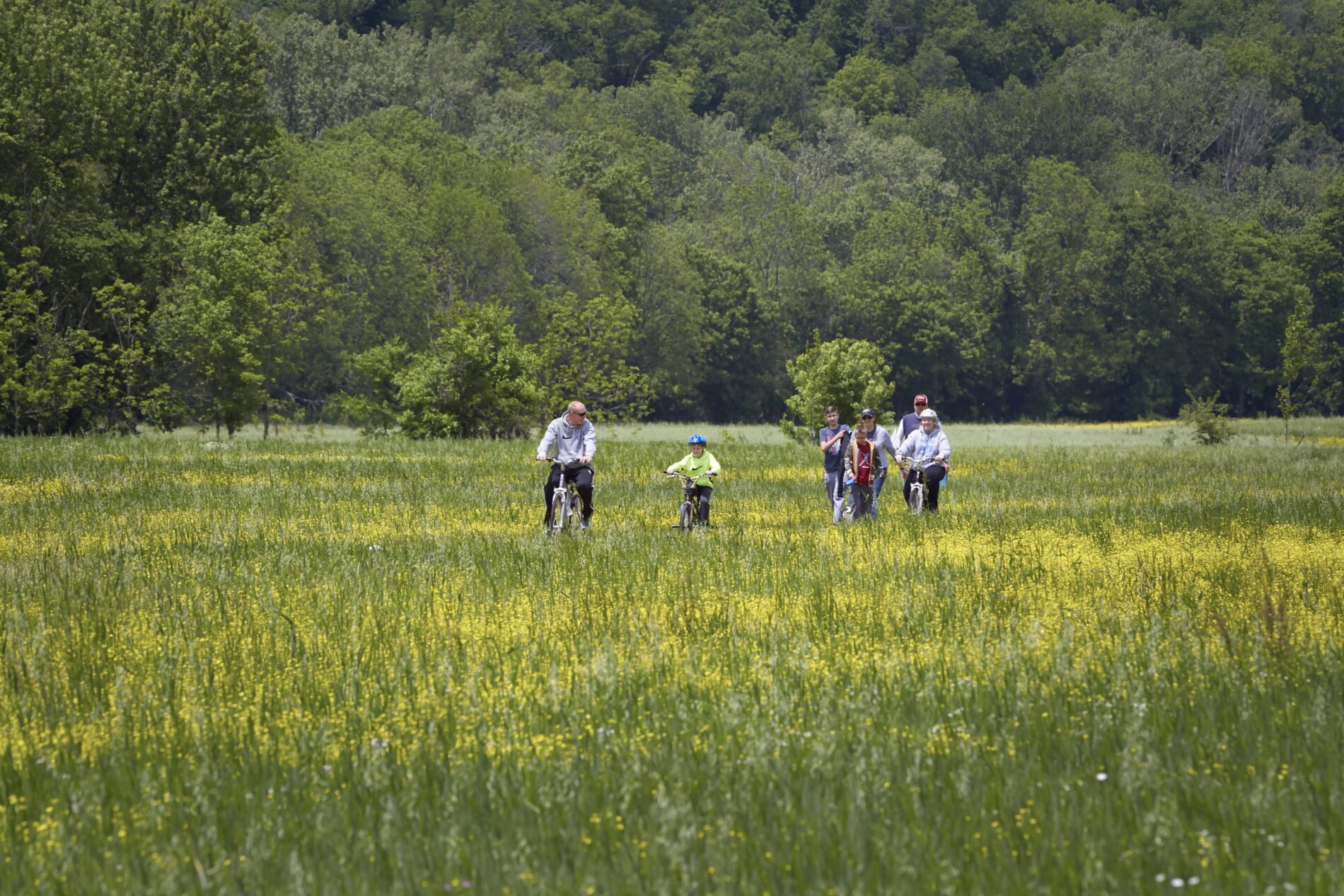 Family riding bikes through Parklands of Floyds Fork