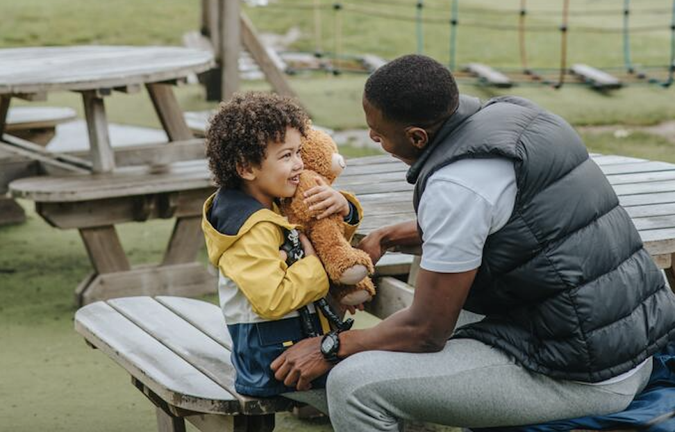 dad talks to son on playground