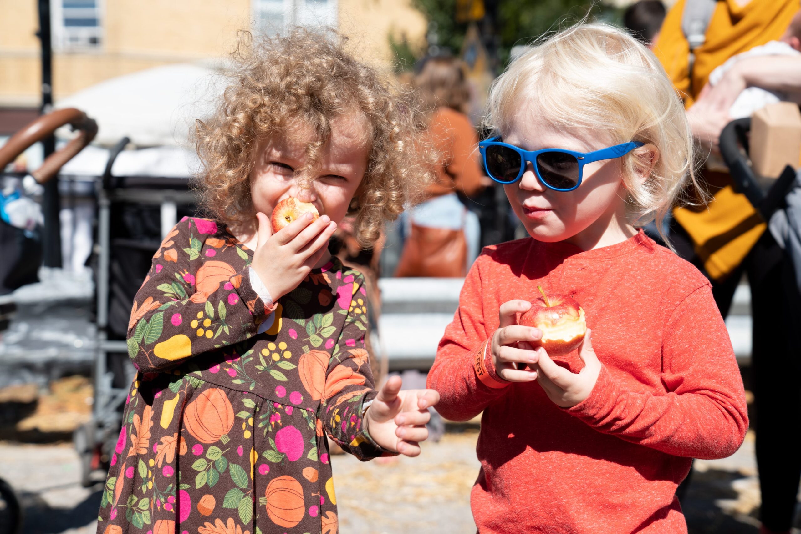 two children eating red apples at Apple Fest in Chicago
