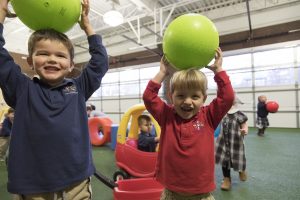 preschool boys playing with balls in indoor play area