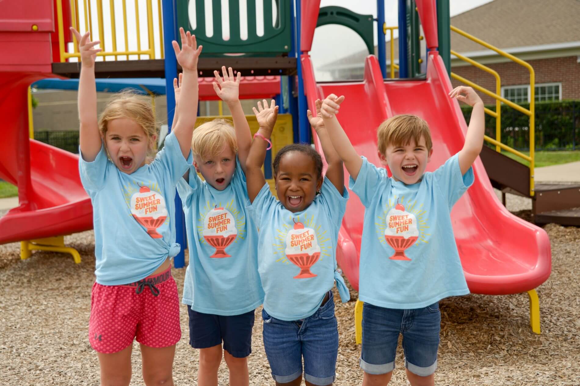 four camp gardner preschoolers on a playground