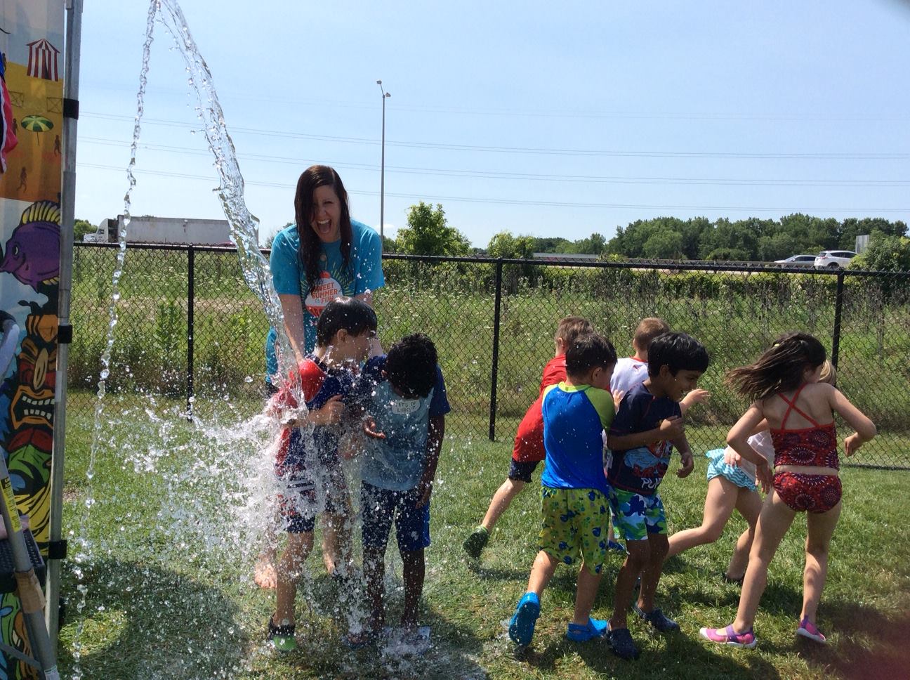 Preschoolers playing in water at camp