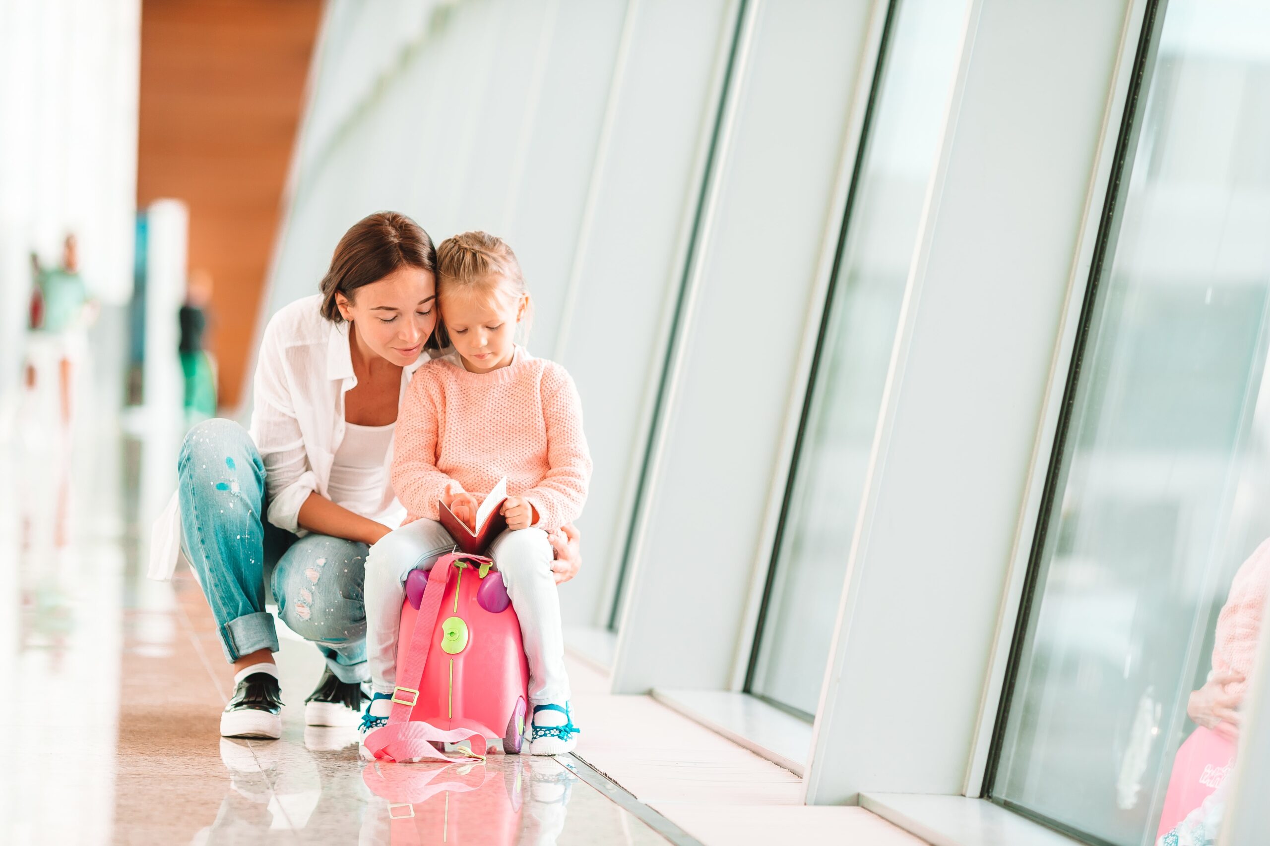 mom and young daughter waiting at the airport