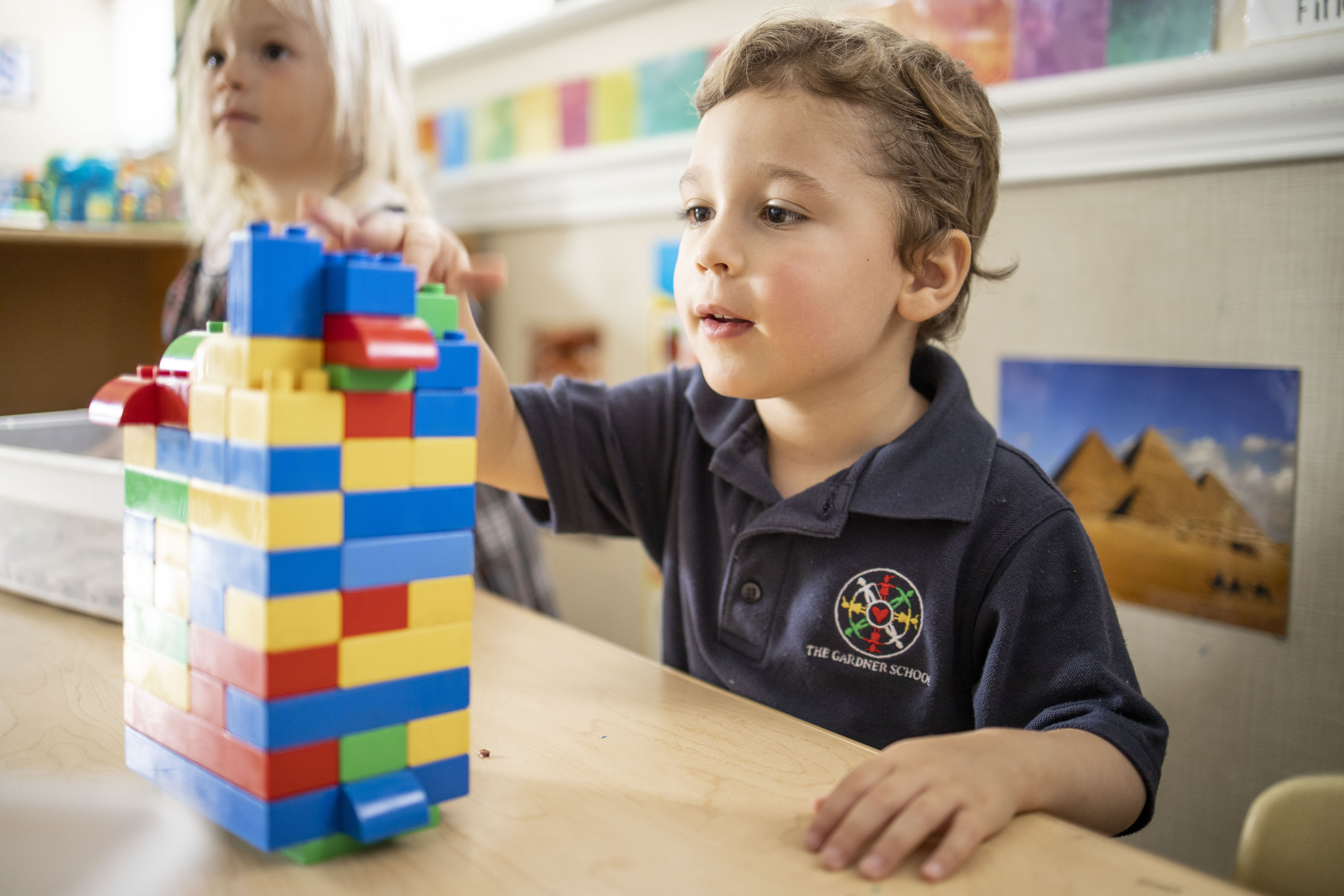 toddler building with Legos at Denver preschool