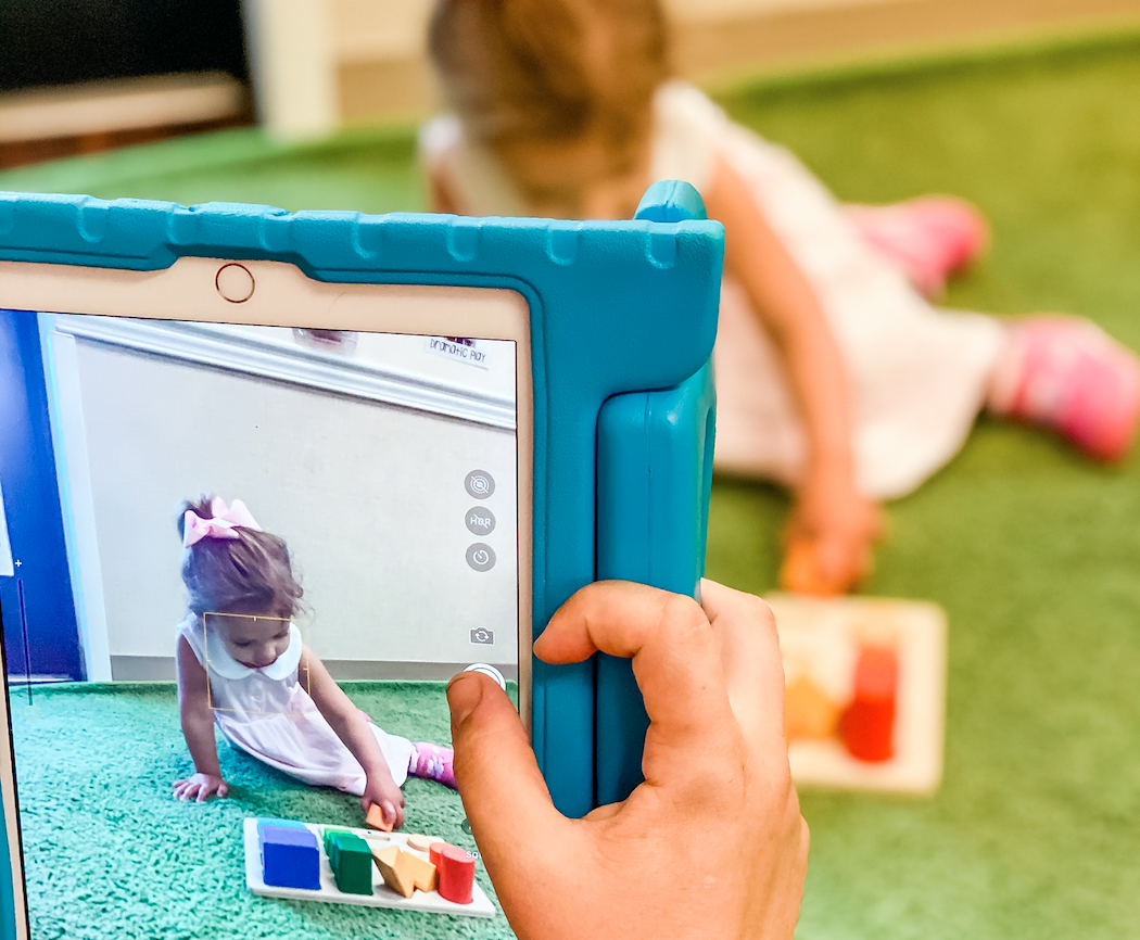 TGS-employee-taking-video-of-student-to-send-live-updates-to-parents