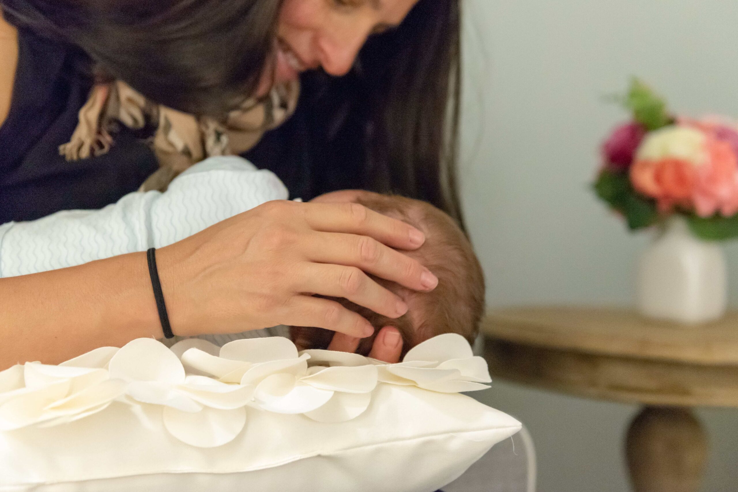 woman holding infant baby closely