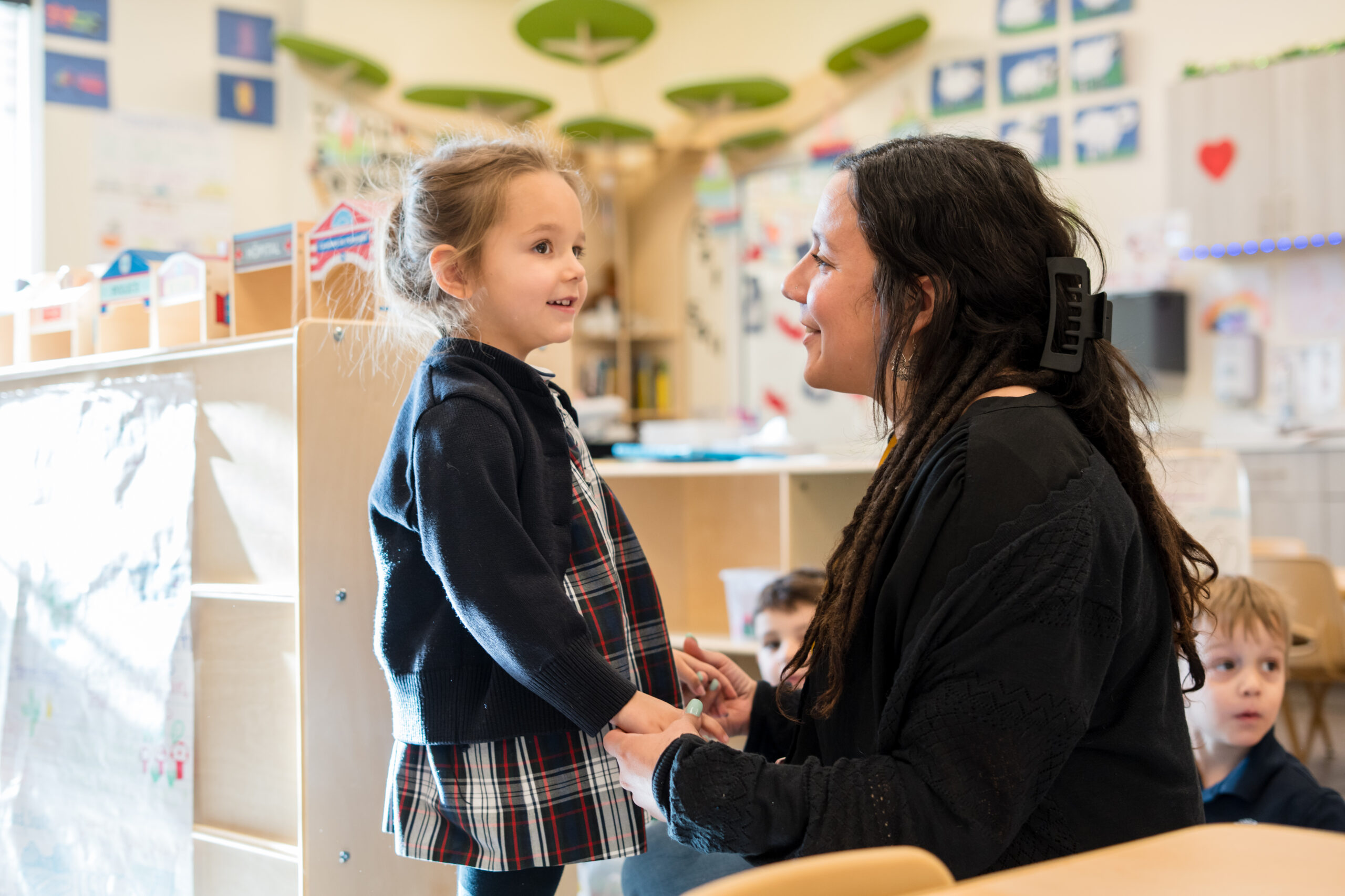 teacher and preschool child talking