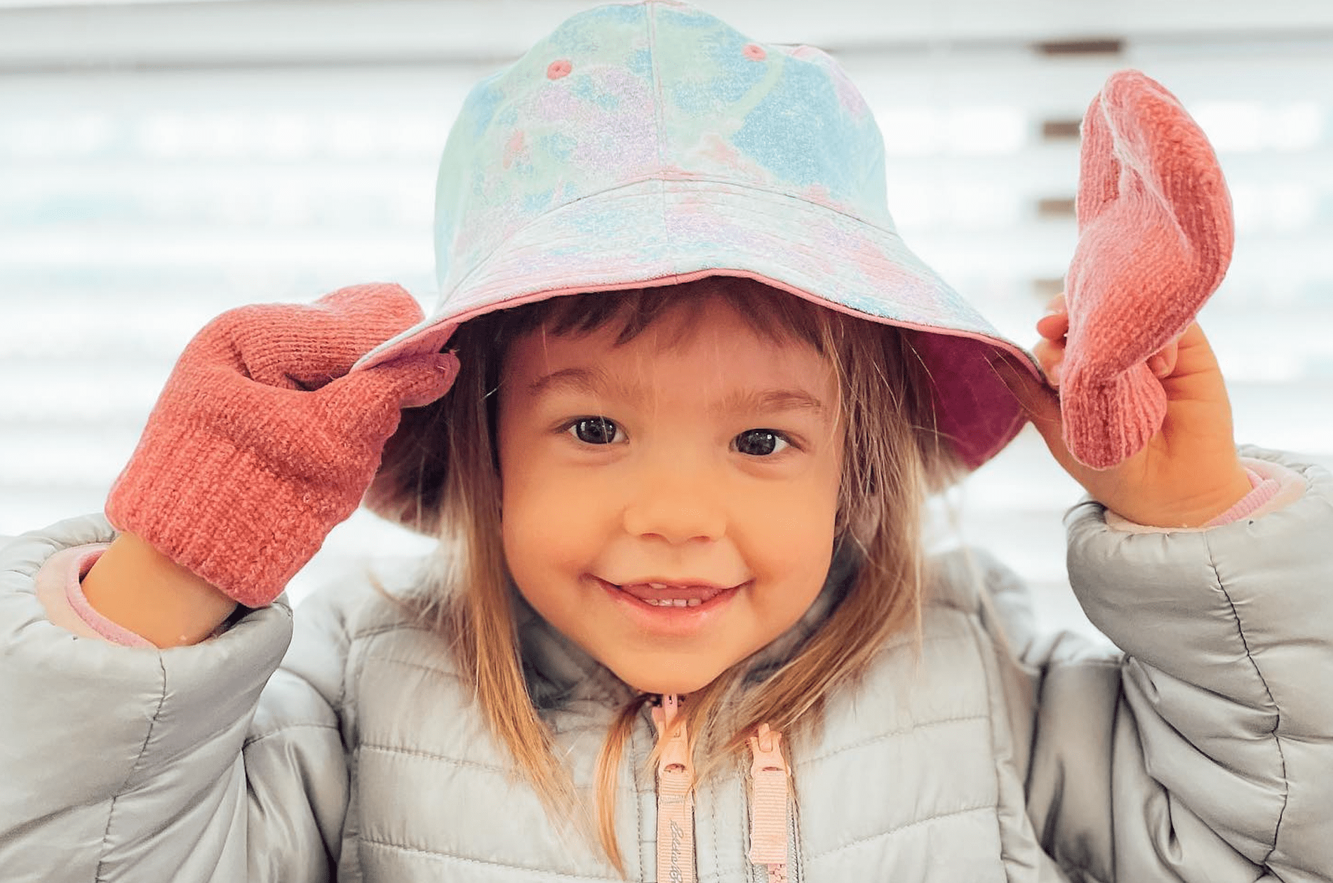 Preschool-Girl-Putting-On-Hat-Gloves-Jacket