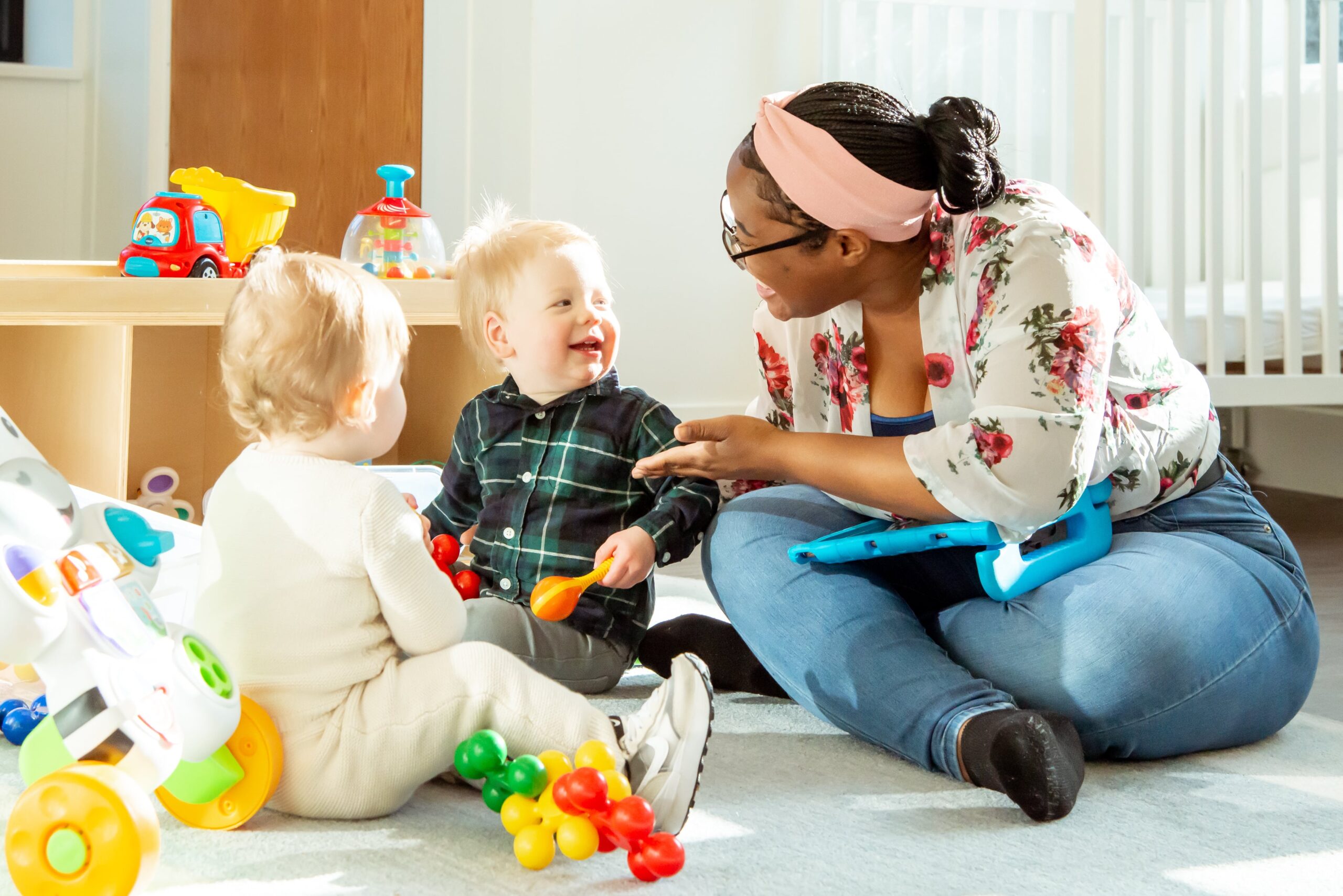 preschool teacher playing with 2 toddlers