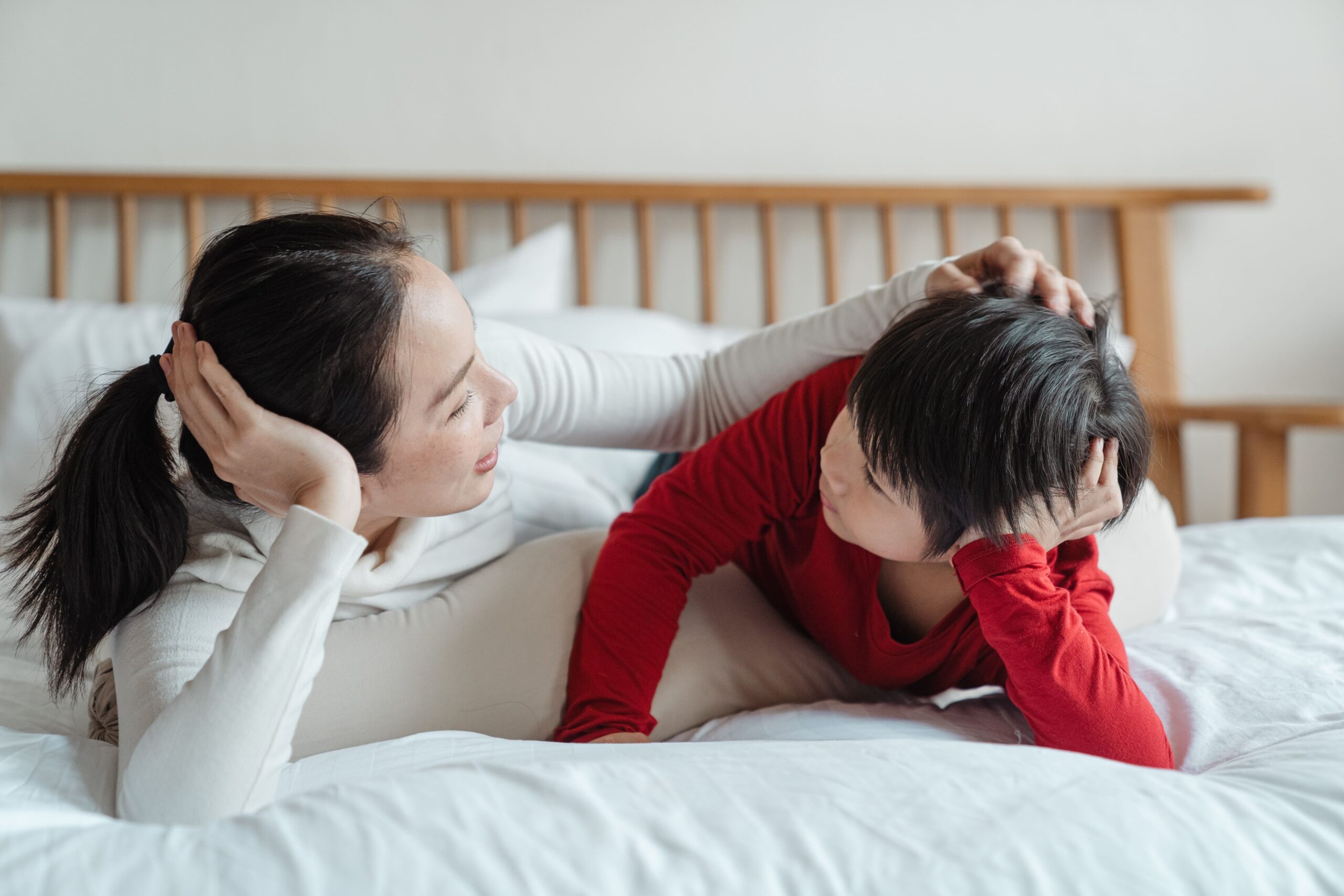 mom talking to son on bed