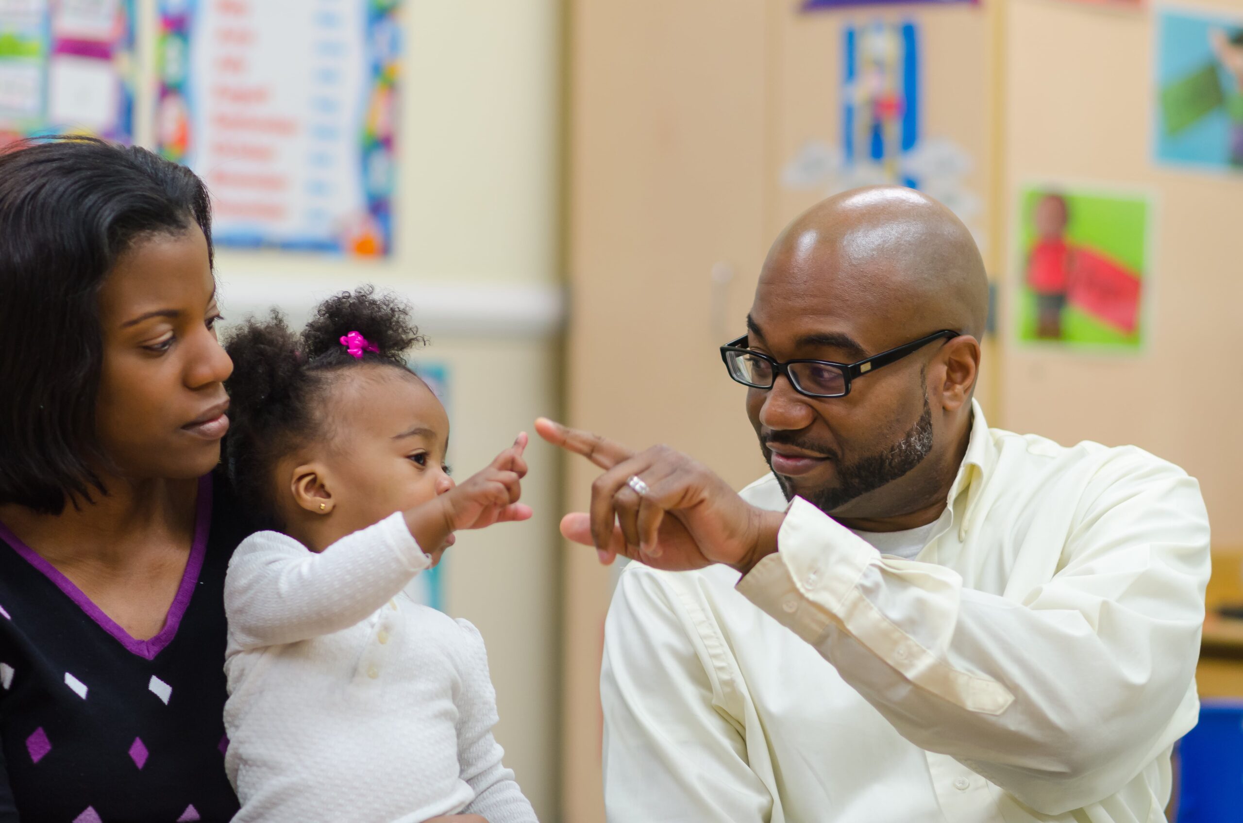 parents sitting with toddler at a preschool