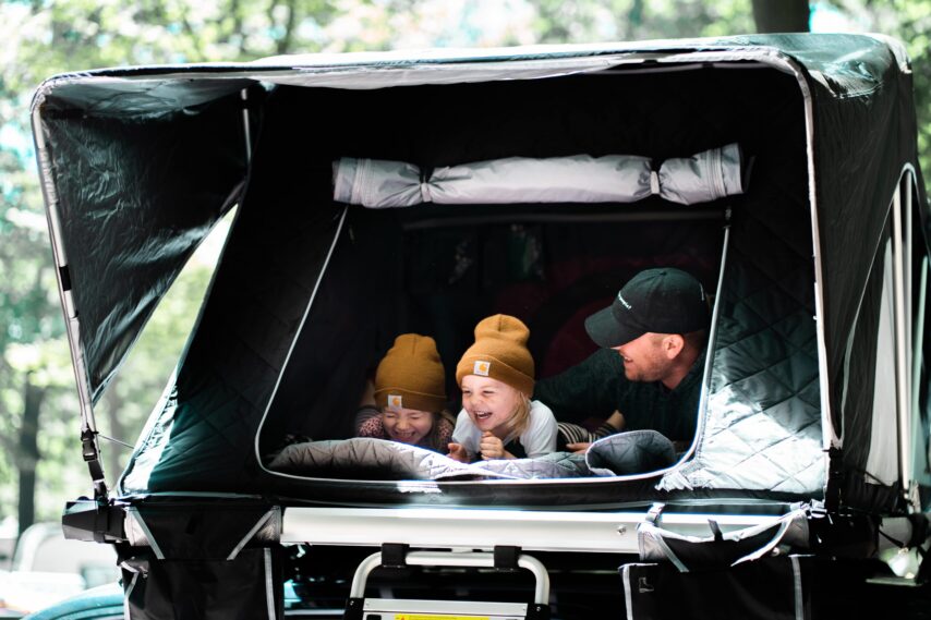 dad and kids camping in tent