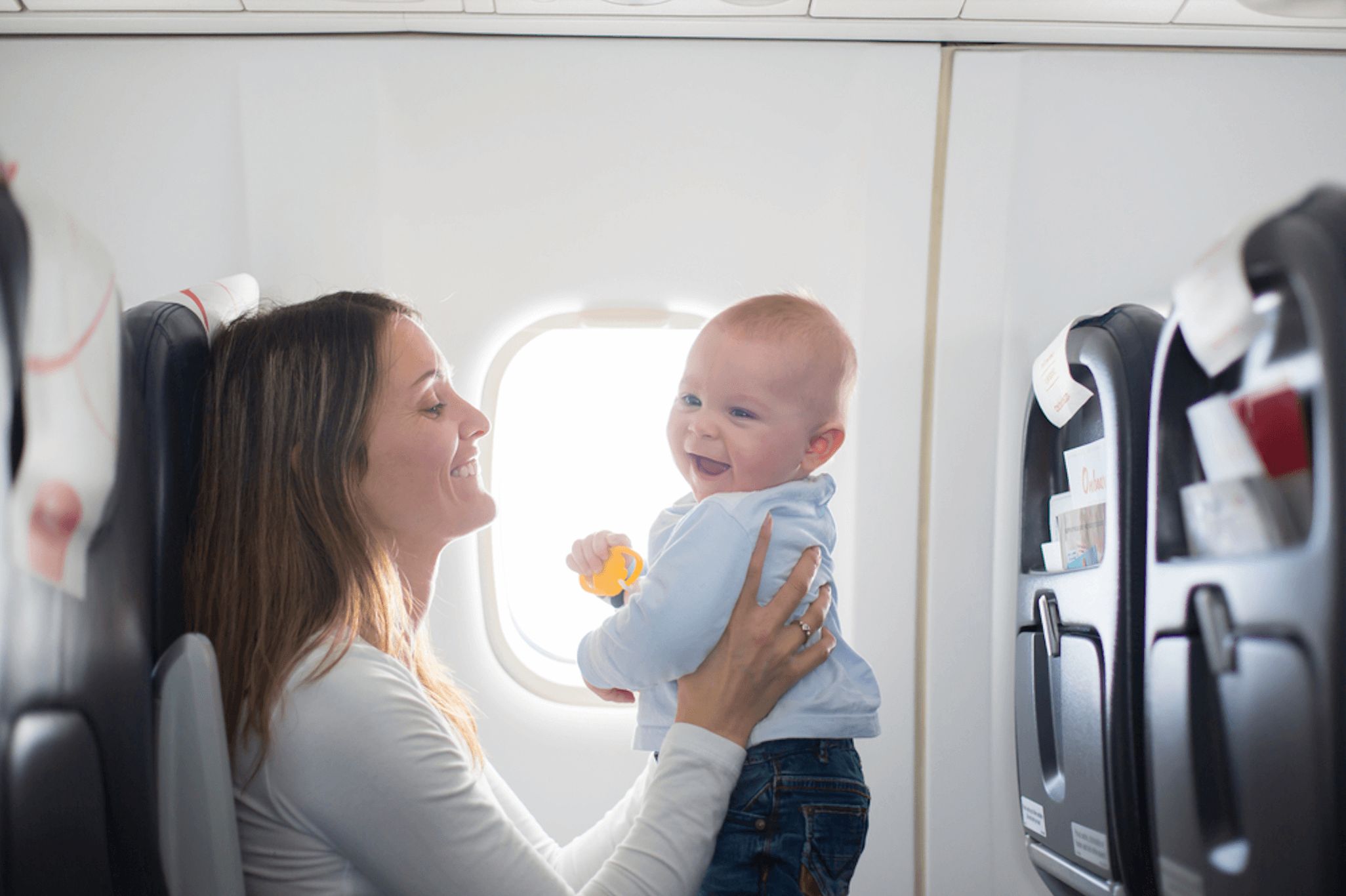 mom holding baby on a plane