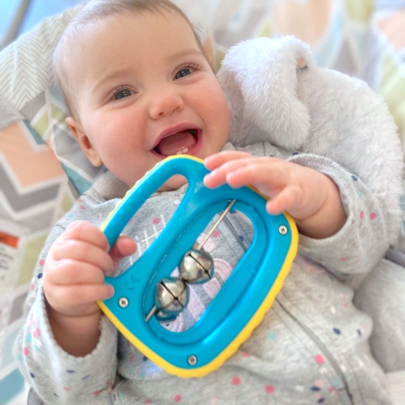 happy baby with easy to hold rattle