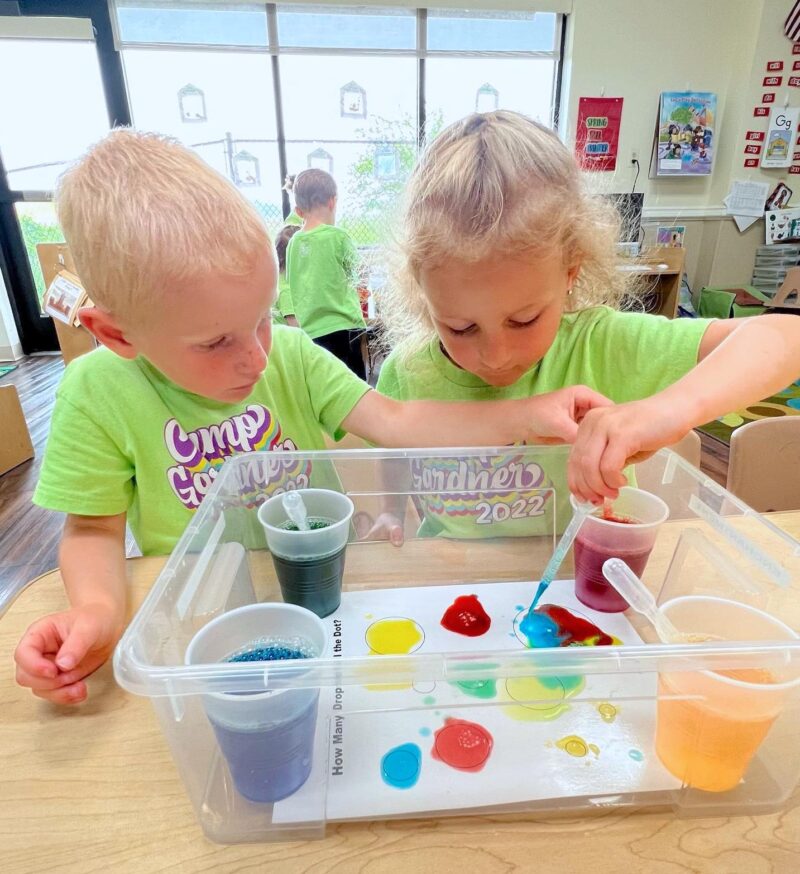 boy and girl do science experiment with colors