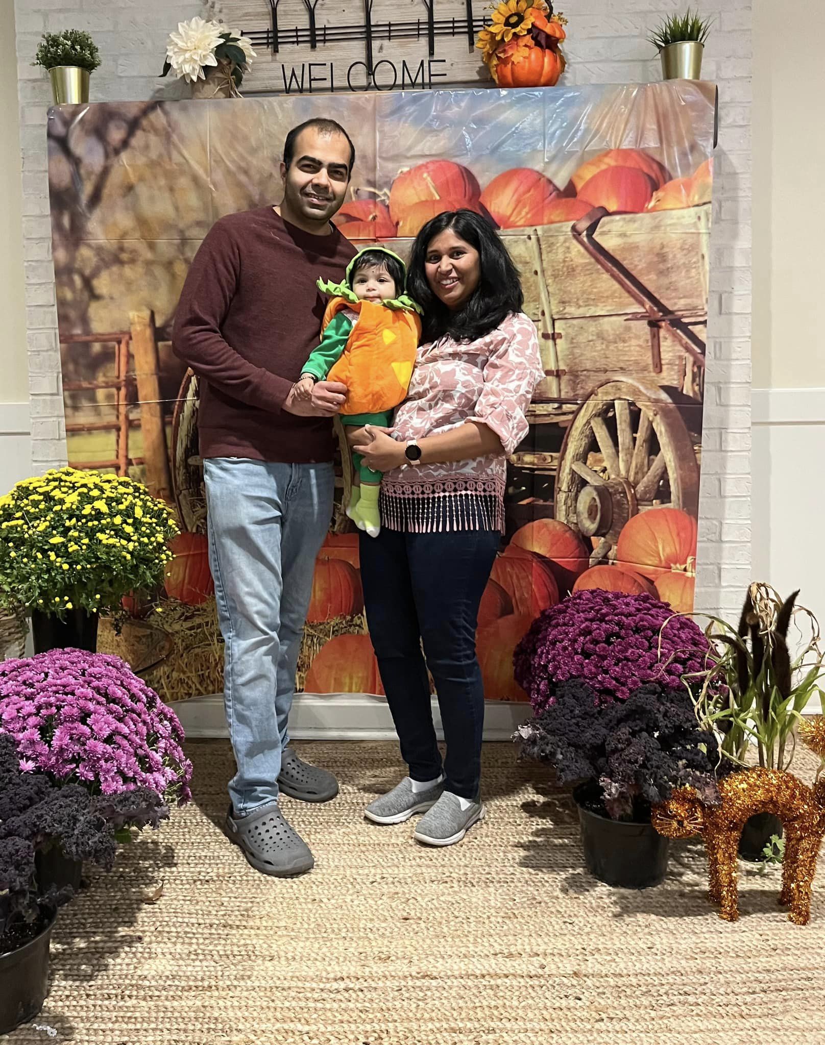 family smiling at fall fest