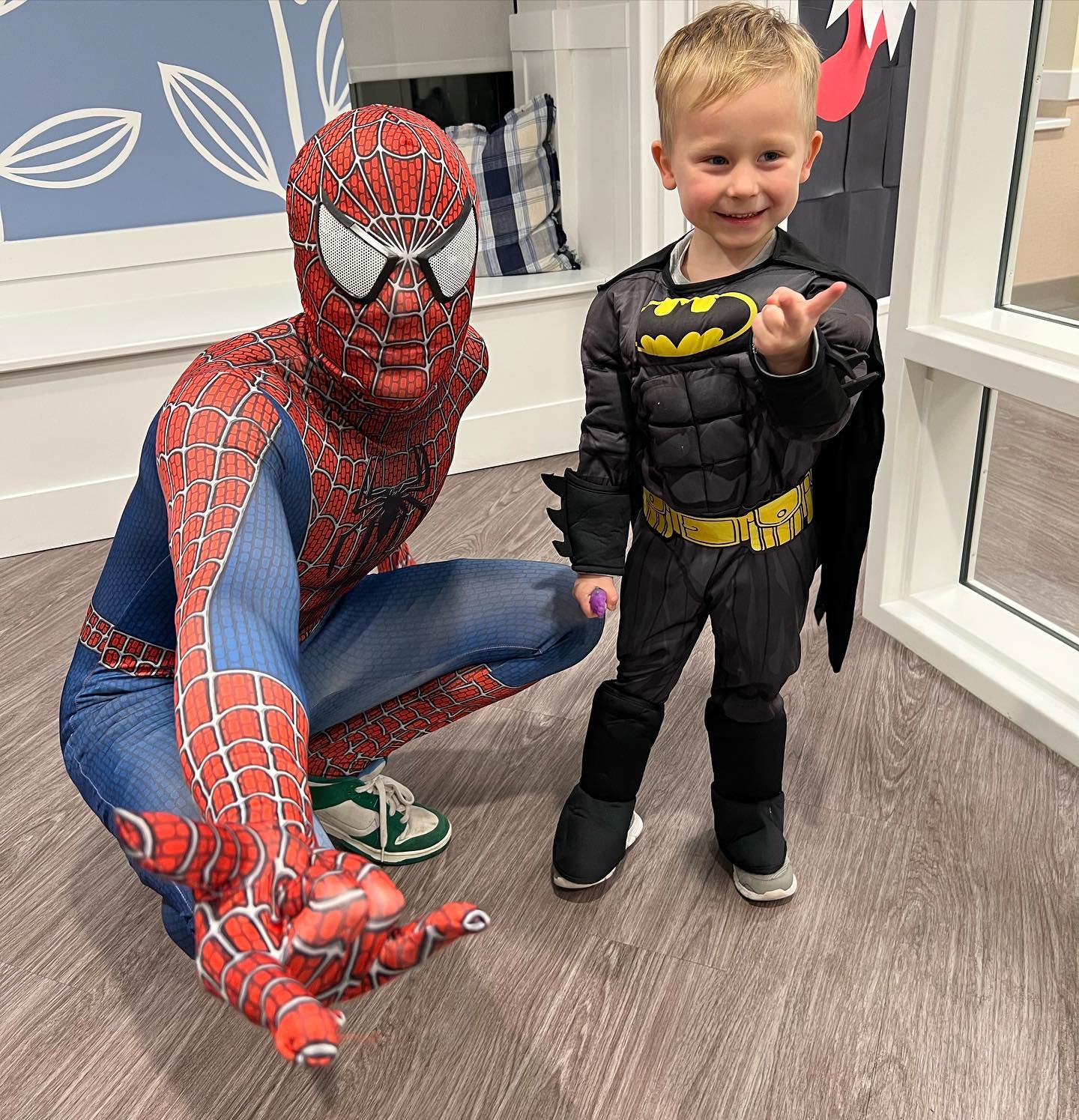 kid dressed as batman with spiderman