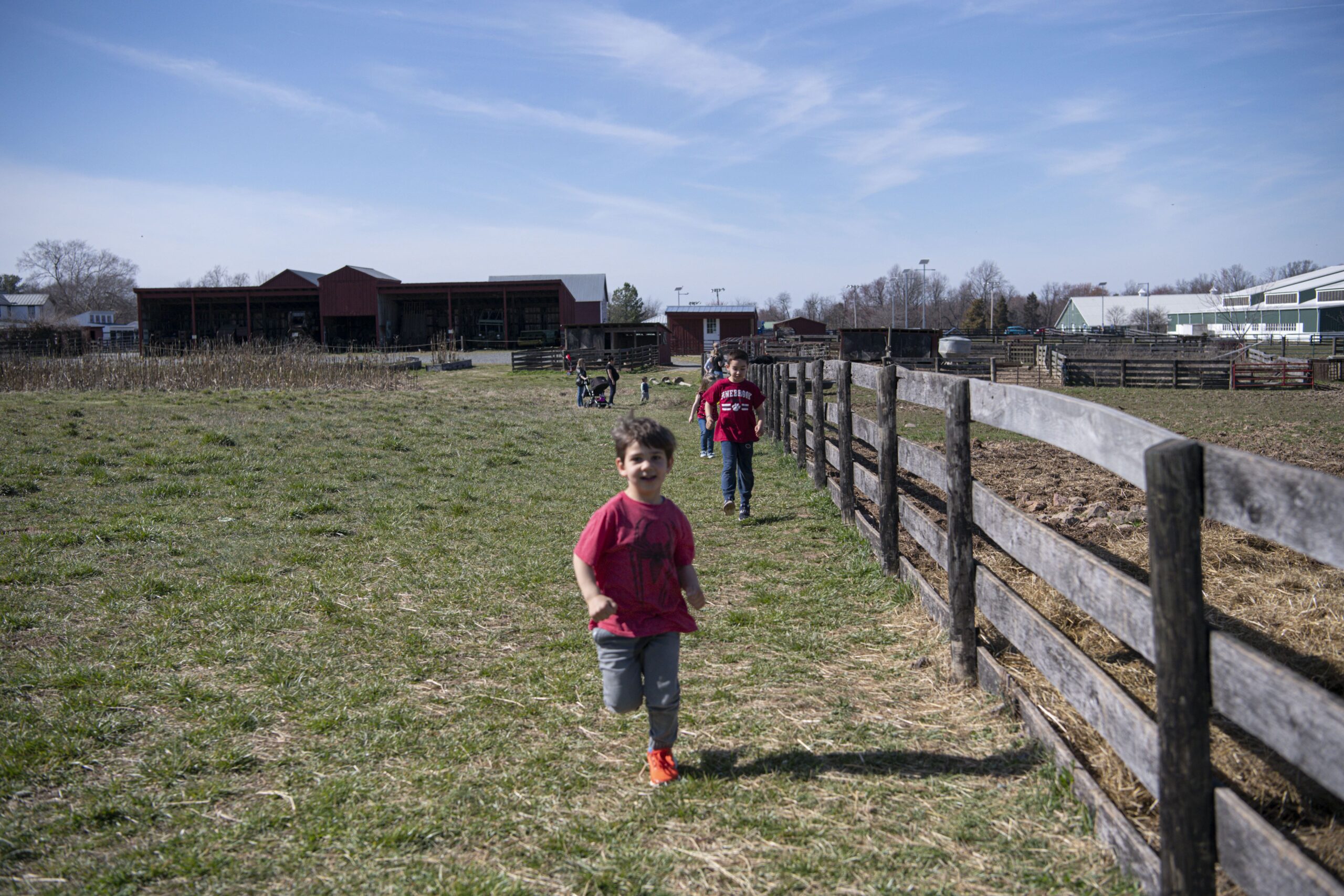 kids running along fence at Frying Pan Farm Park