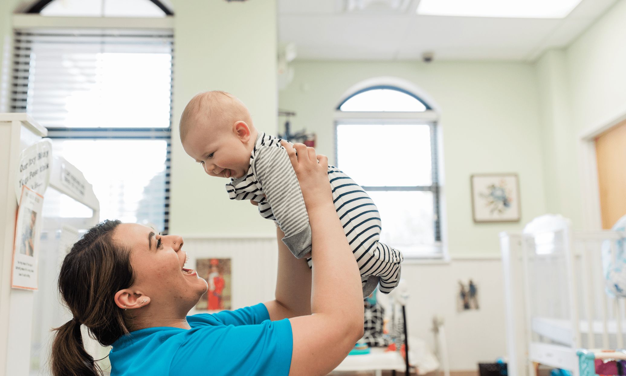 teacher and baby playing at school