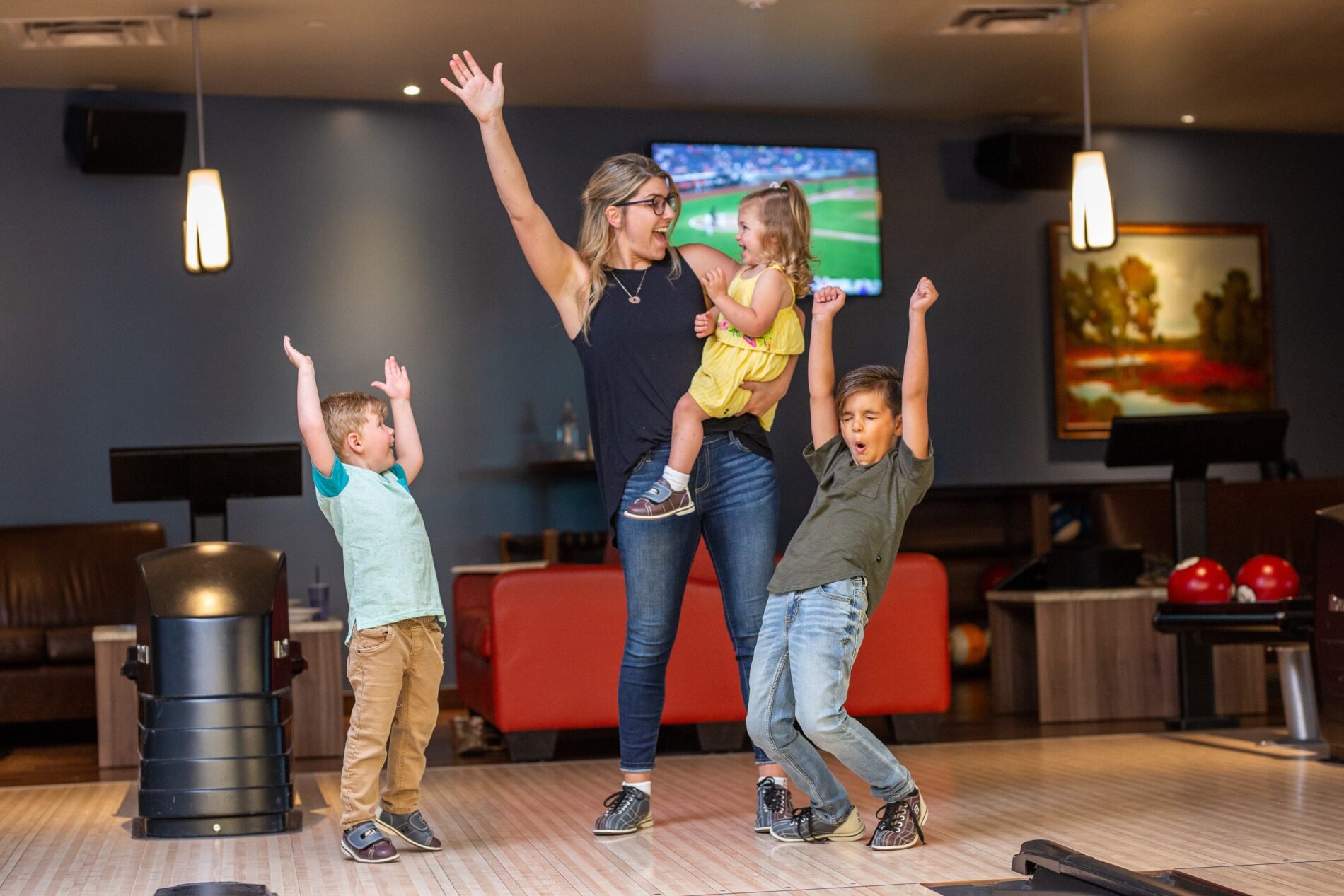 family celebrating at Pinstripes Bowling & Bocce
