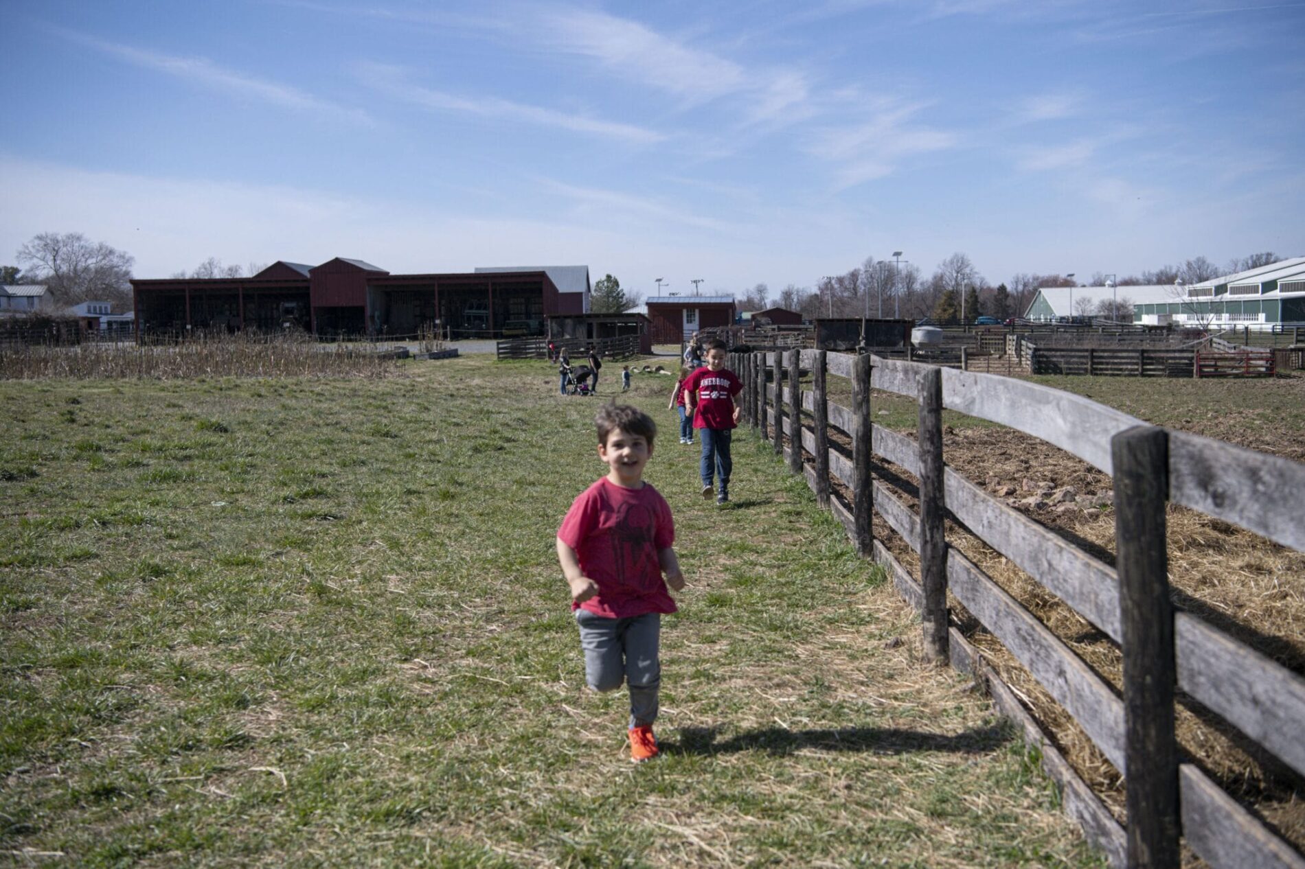 child running along fence in Frying Pan Park