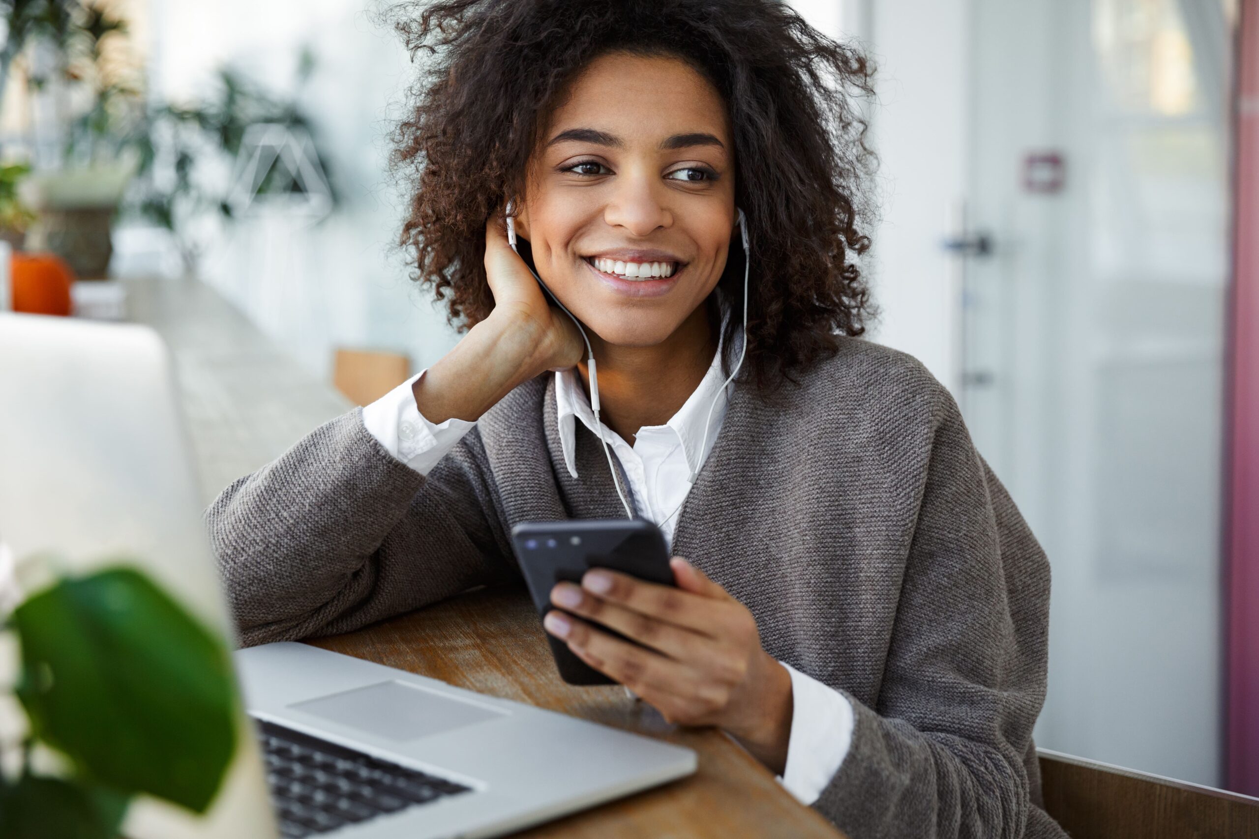 woman listening to a parenting podcast on her phone