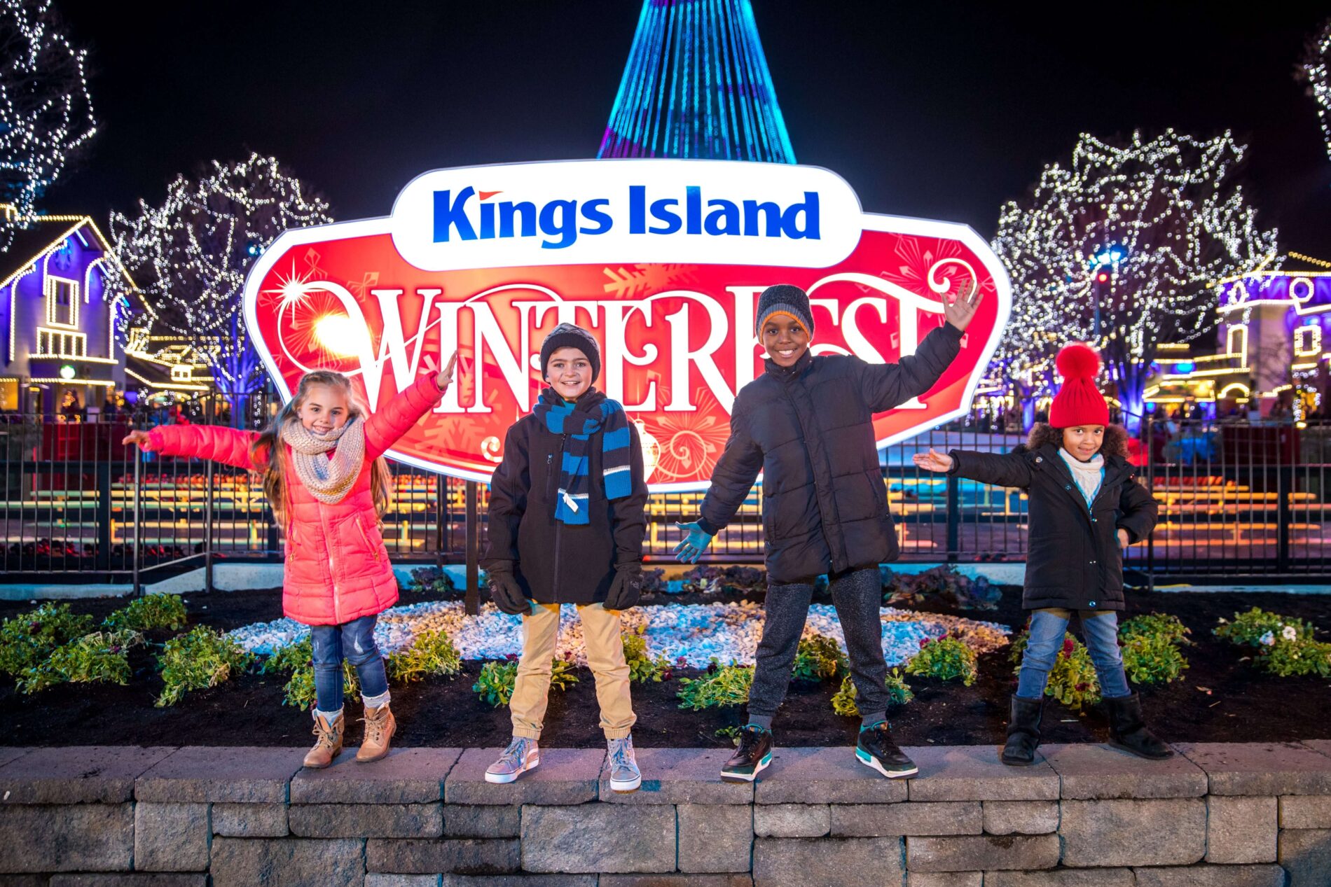 children standing in front of Kings Island Winterfest sign