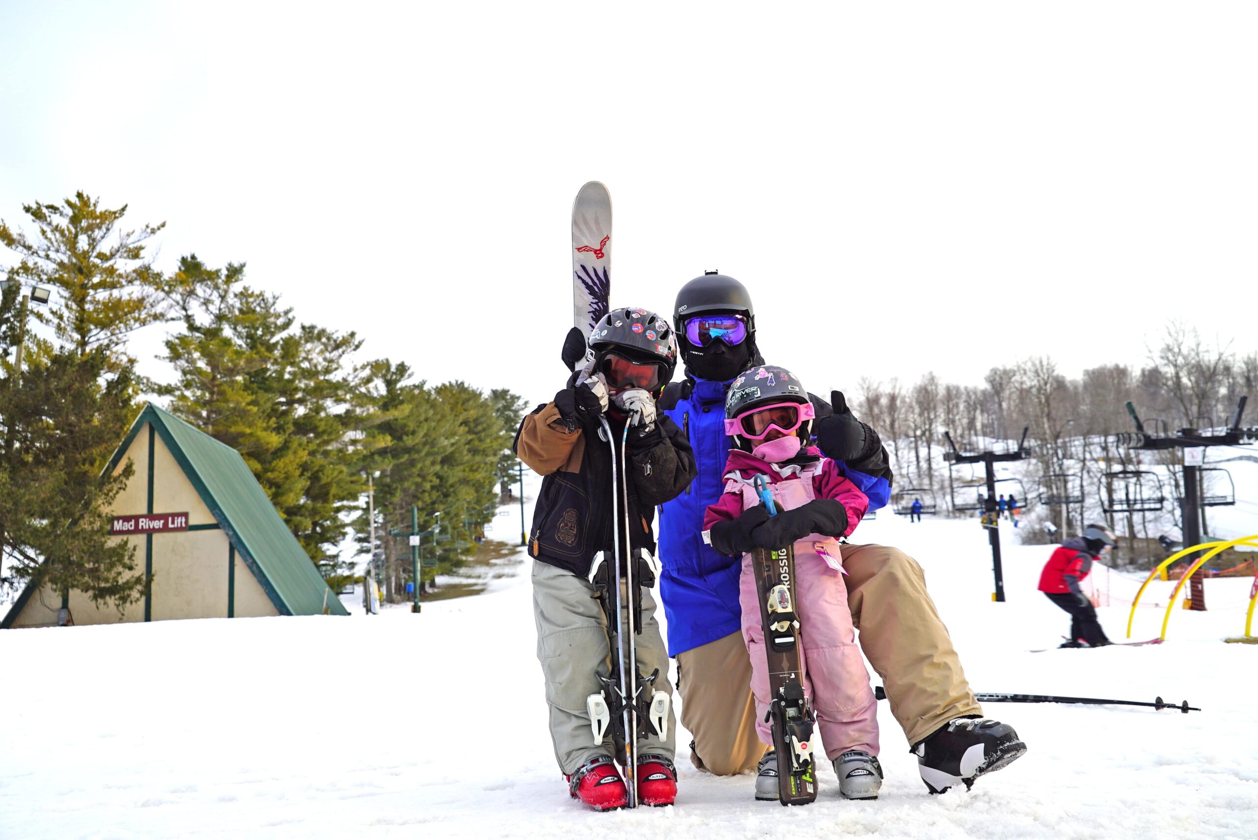 parent and two children posing with skis at Mad River Mountain in Columbus Ohio