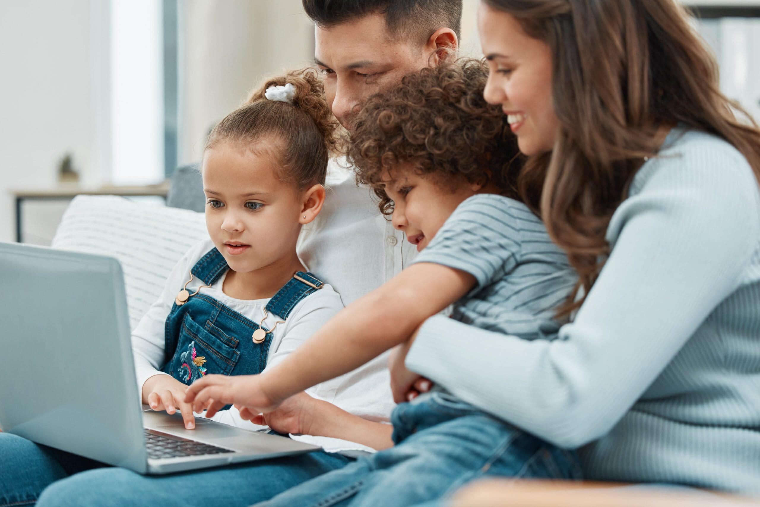 family looking at a laptop screen together