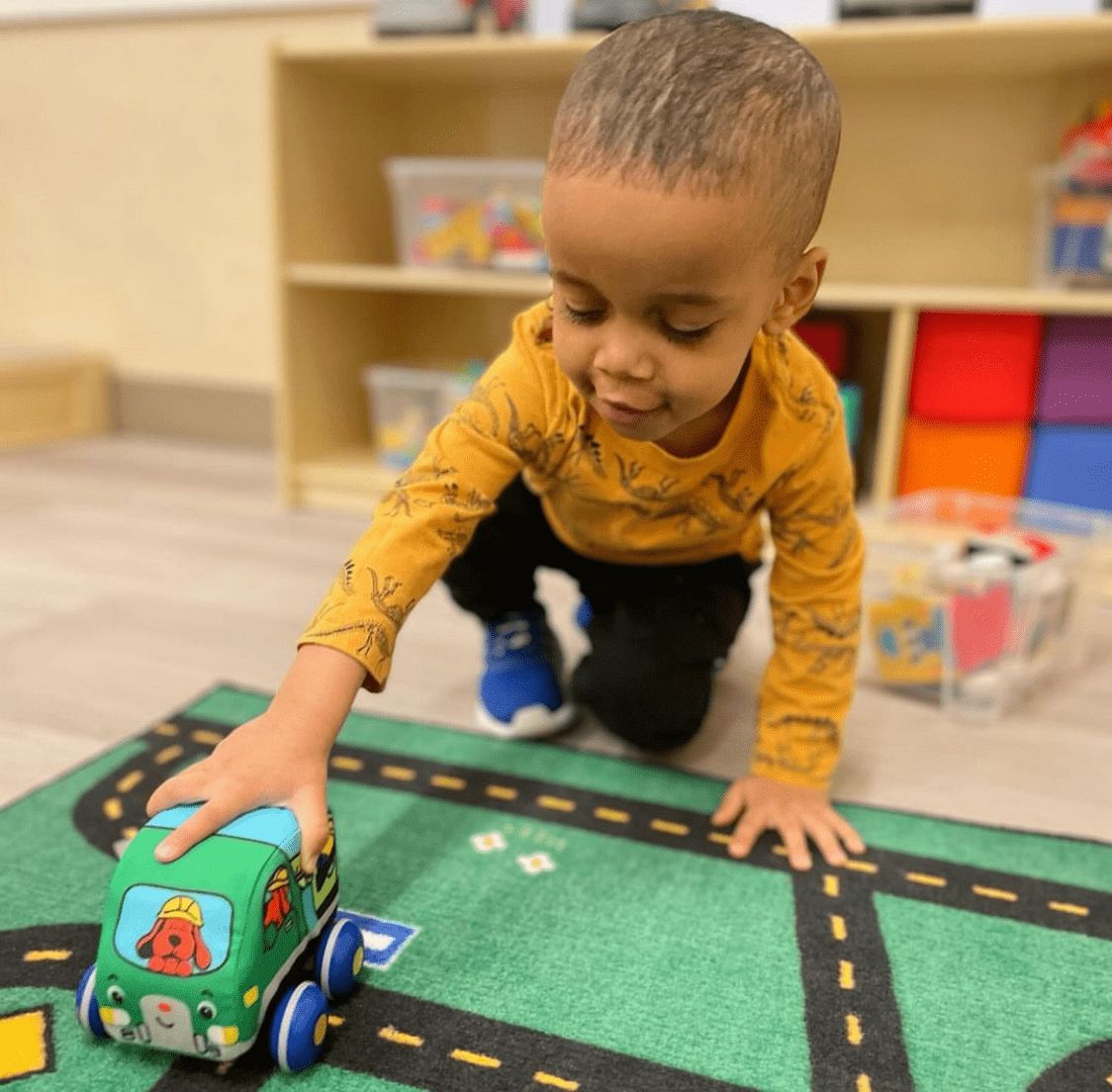 Little boy playing with a toy car