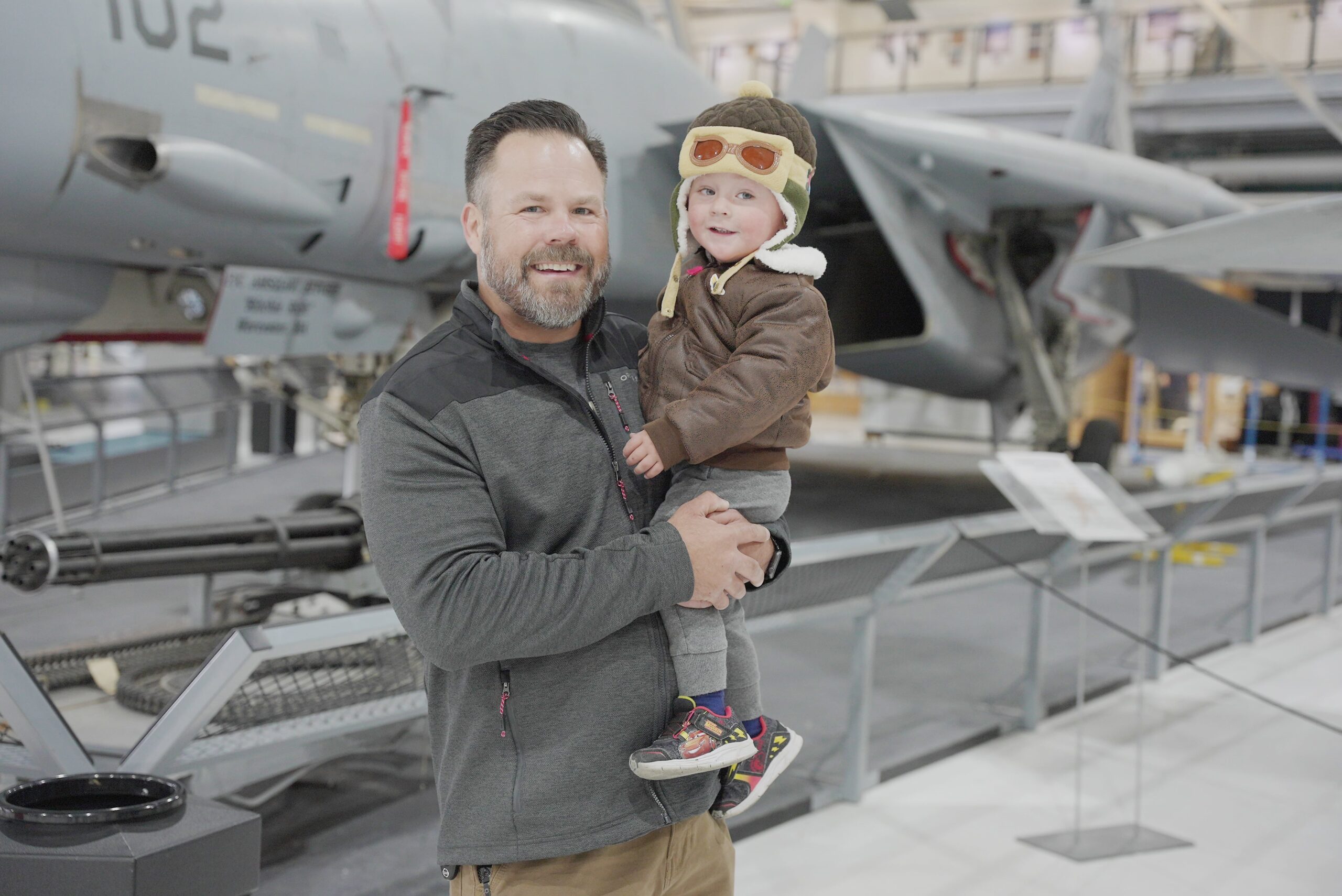 dad and young son in front of a plane at Wings Over The Rockies