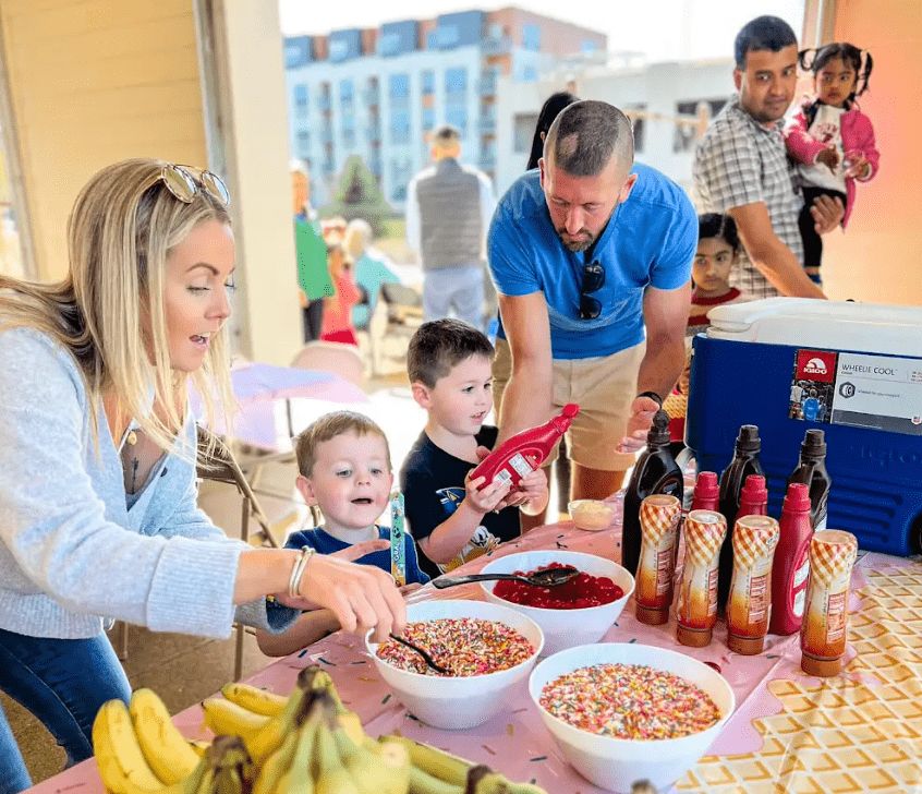 students and parents enjoying an ice cream sundae bar