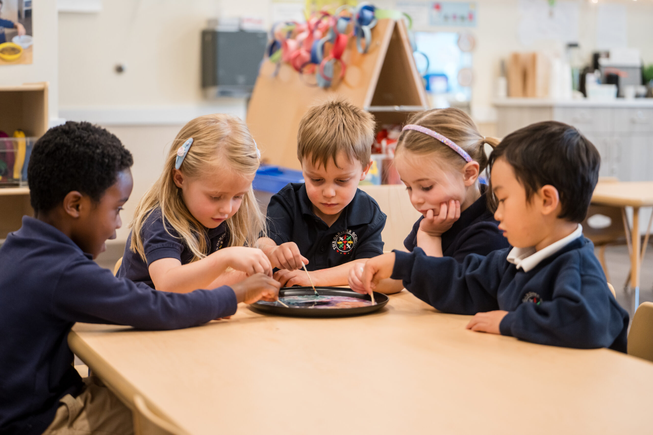 preschool students engaged in science experiment