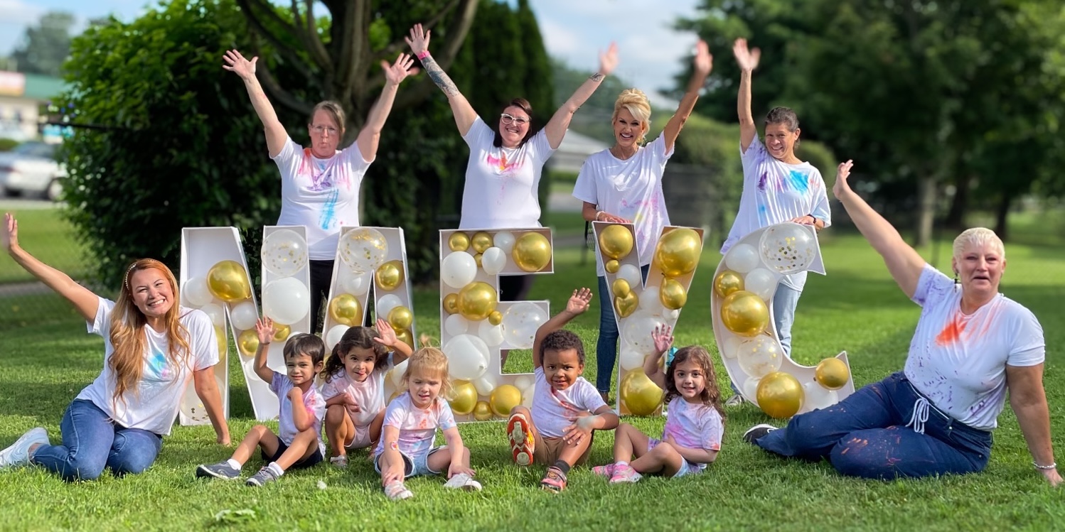 teachers celebrating NAEYC accreditation