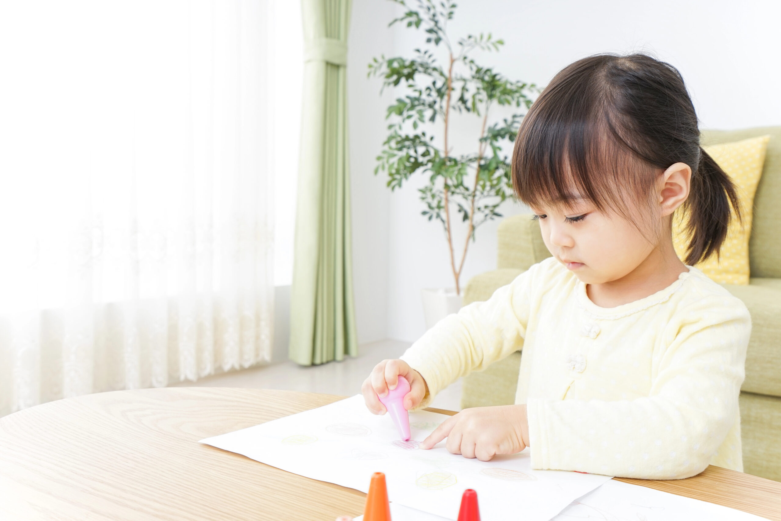 young child painting pictures at home