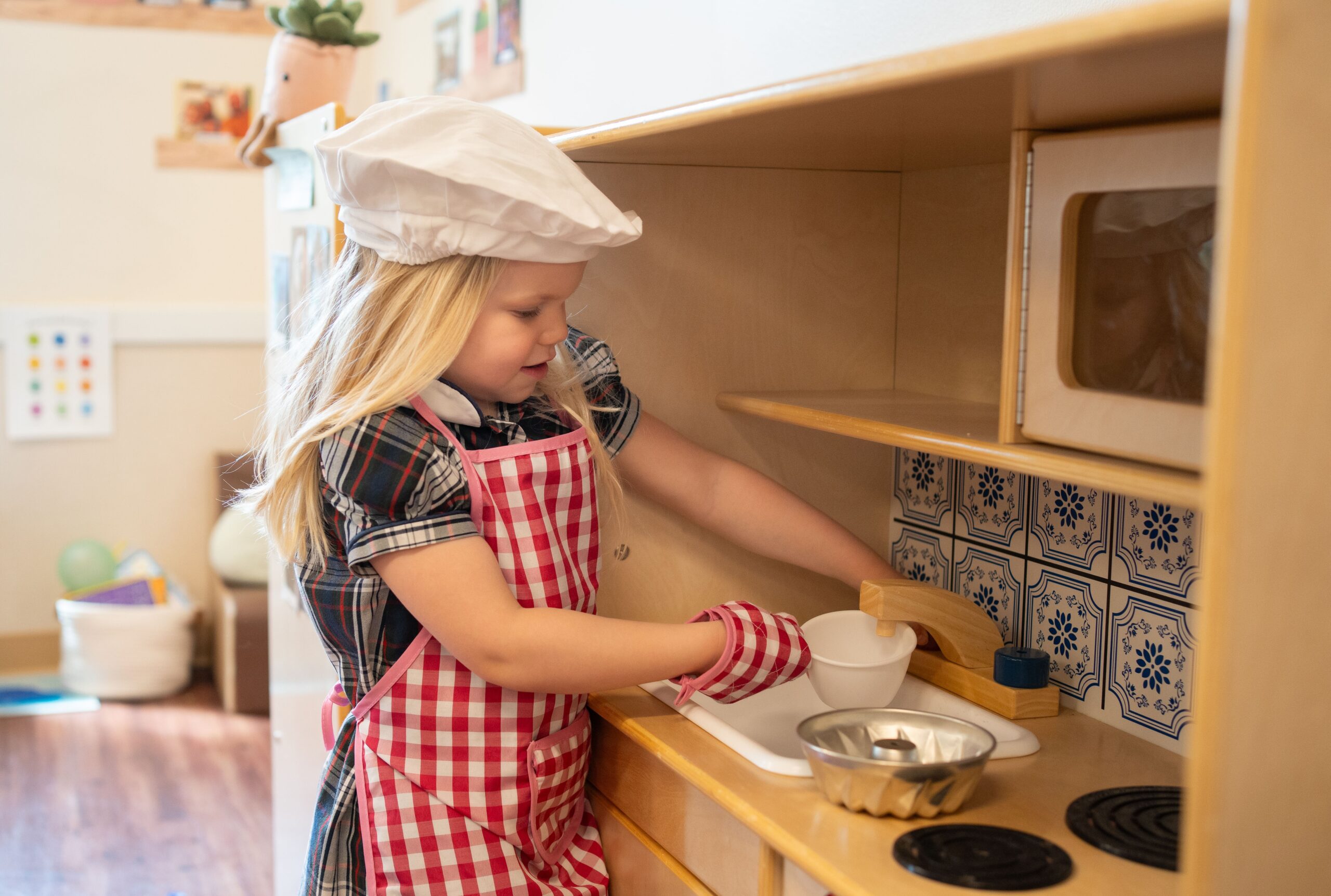 young child pretend cooking at preschool