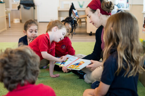 teacher reading with students in preschool