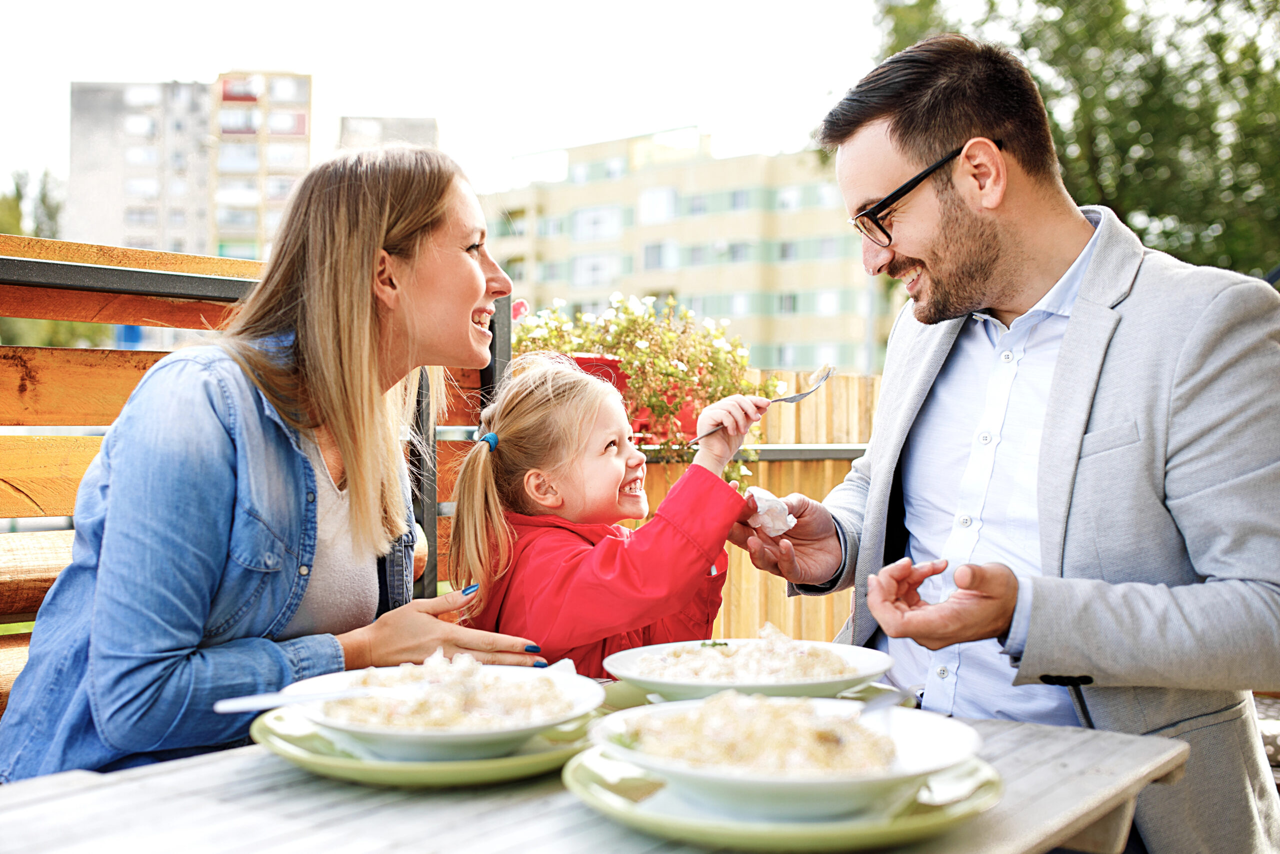 family eating out at outside restaurant