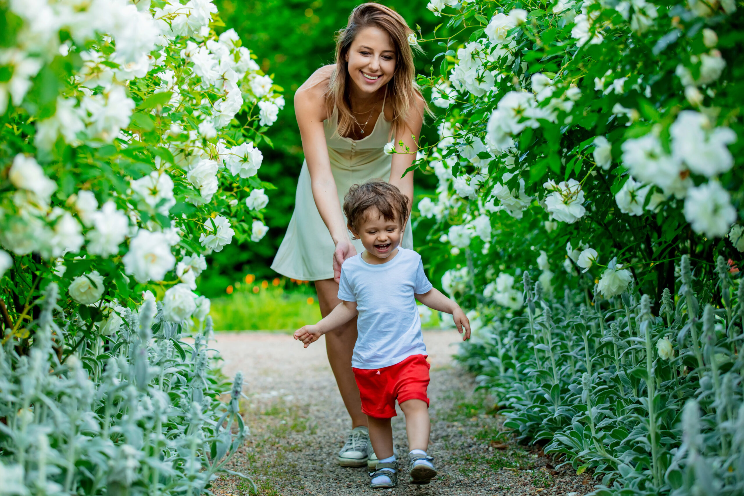 mom and young son in flower garden