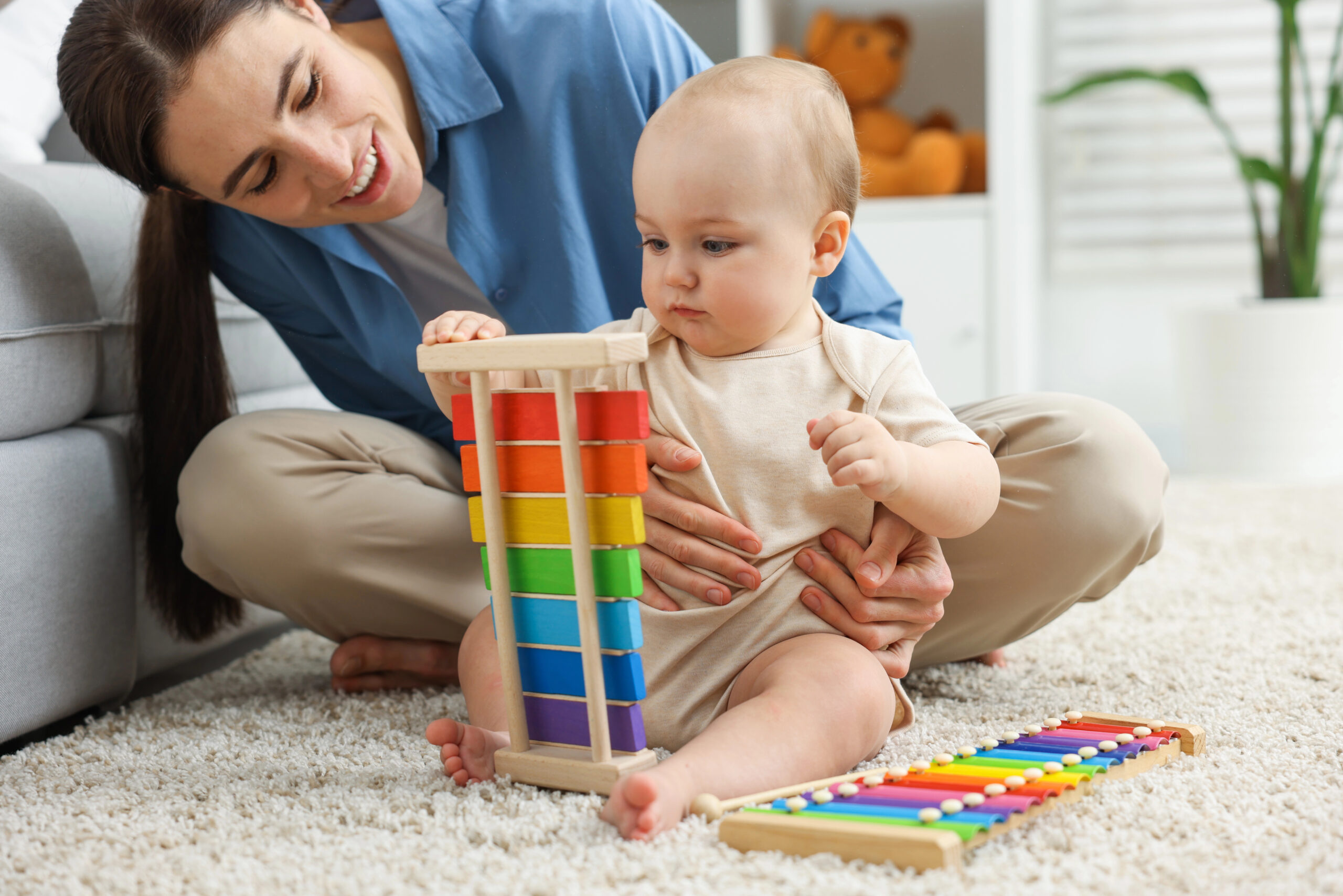 mom and infant playing on the floor