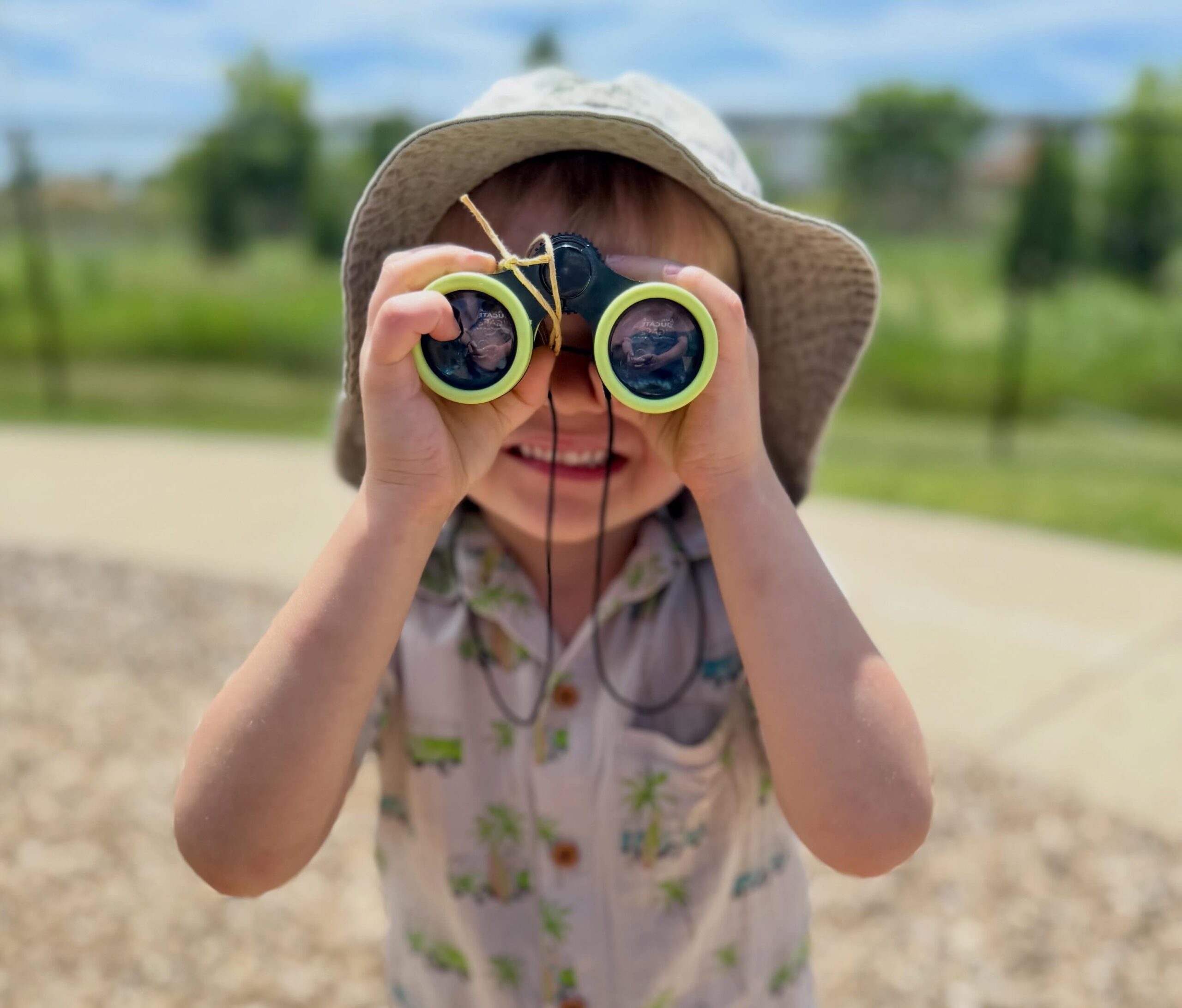 Child with binoculars outside