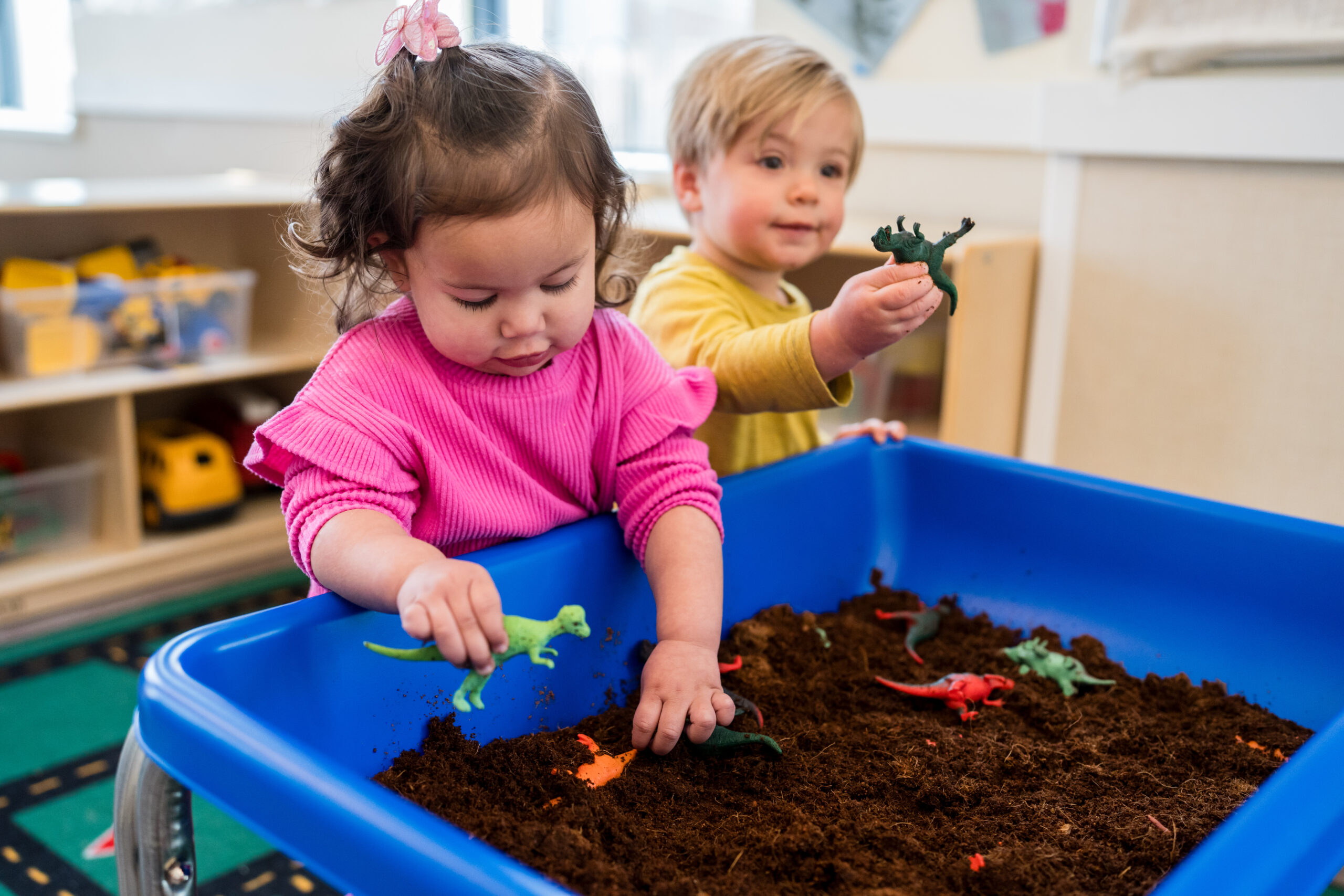 two children playing in sensory bin